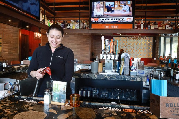 Sophia Piersall, a bartender at Foxy Brown, serves drinks to patrons in Fort Lauderdale on Friday, May 1, 2026. The downtown comfort-food landmark, owned by Elliot Wolf and the Be Nice Restaurants group, has announced it will permanently close on May 10 following Mother's Day dinner service. (Carline Jean/South Florida Sun Sentinel)
