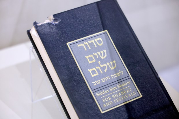 A Siddur that was damaged by gunfire during the Tree of Life Synagogue shootings is on display at the Alvin Sherman Library at Nova Southeastern University in Davie on Monday, May 11, 2026. This during a media preview of an upcoming exhibit, "Lessons from the Tree of Life: Lighting the Path Forward" which explores antisemitism in America, the Pittsburgh synagogue shootings in 2018, and the path forward since.(Amy Beth Bennett / Sun Sentinel)
