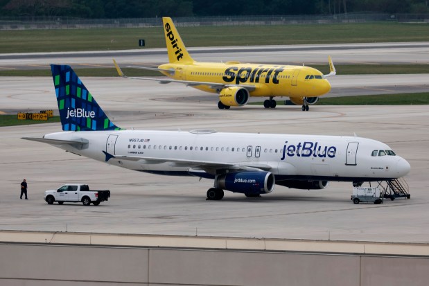 A Spirit Airlines planes and a JetBlue plane on the tarmac at Fort Lauderdale-Hollywood International Airport on Tuesday Jan. 16, 2024. A federal judge in Boston on Tuesday blocked the $3.8 billion takeover of Spirit Airlines by JetBlue Airways, a ruling that will keep the Miramar-based discount carrier independent for now. (Mike Stocker/South Florida Sun Sentinel)
