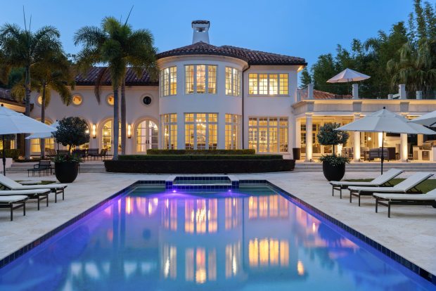Outdoor features, like the courtyards, brick patios and pool terrace, are all staples of South Florida architect Addison Mizner, whose work inspired the design. (Courtesy of Uneek Image)