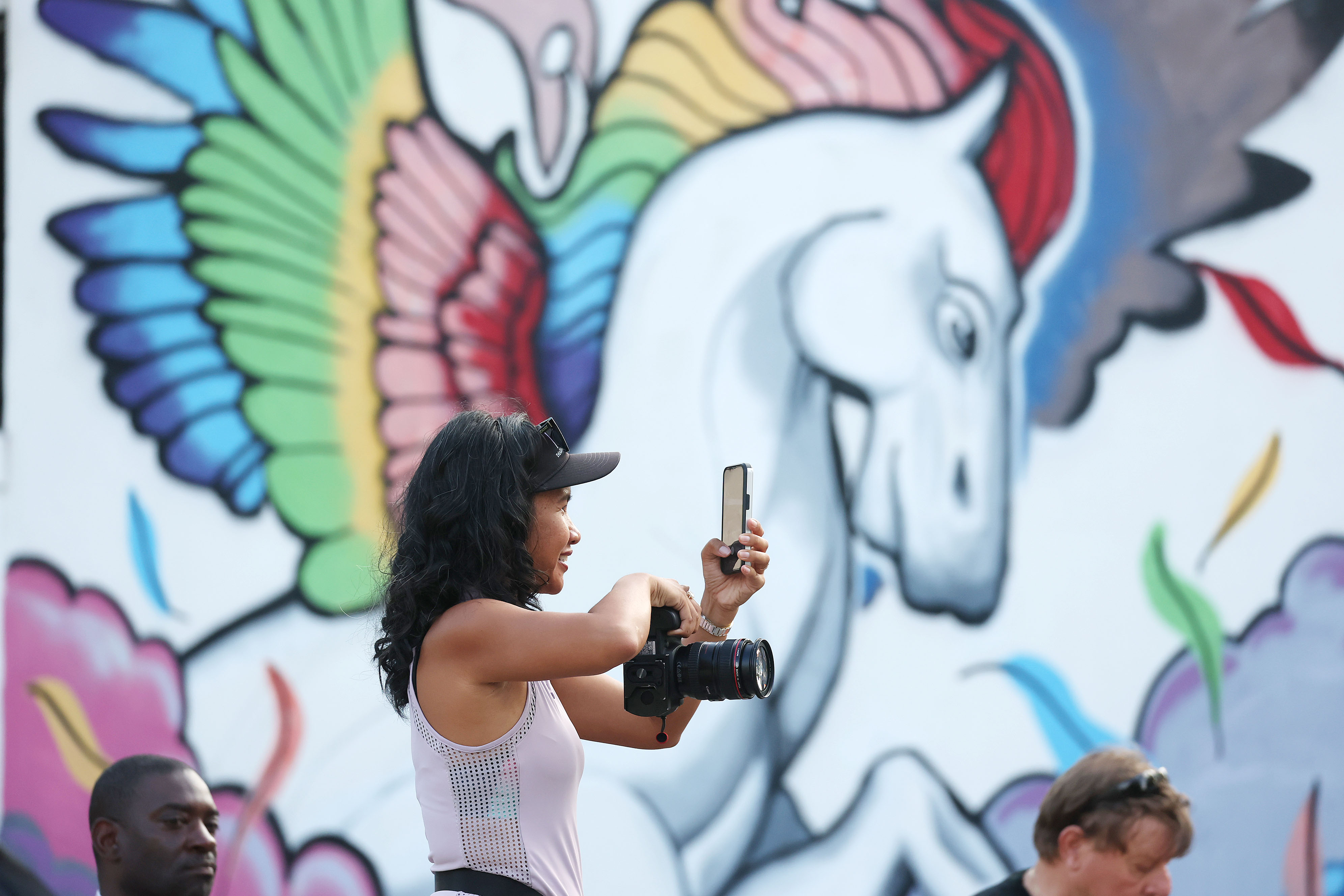 A spectator takes photos during the 32nd AdventHealth Corporate 5K...