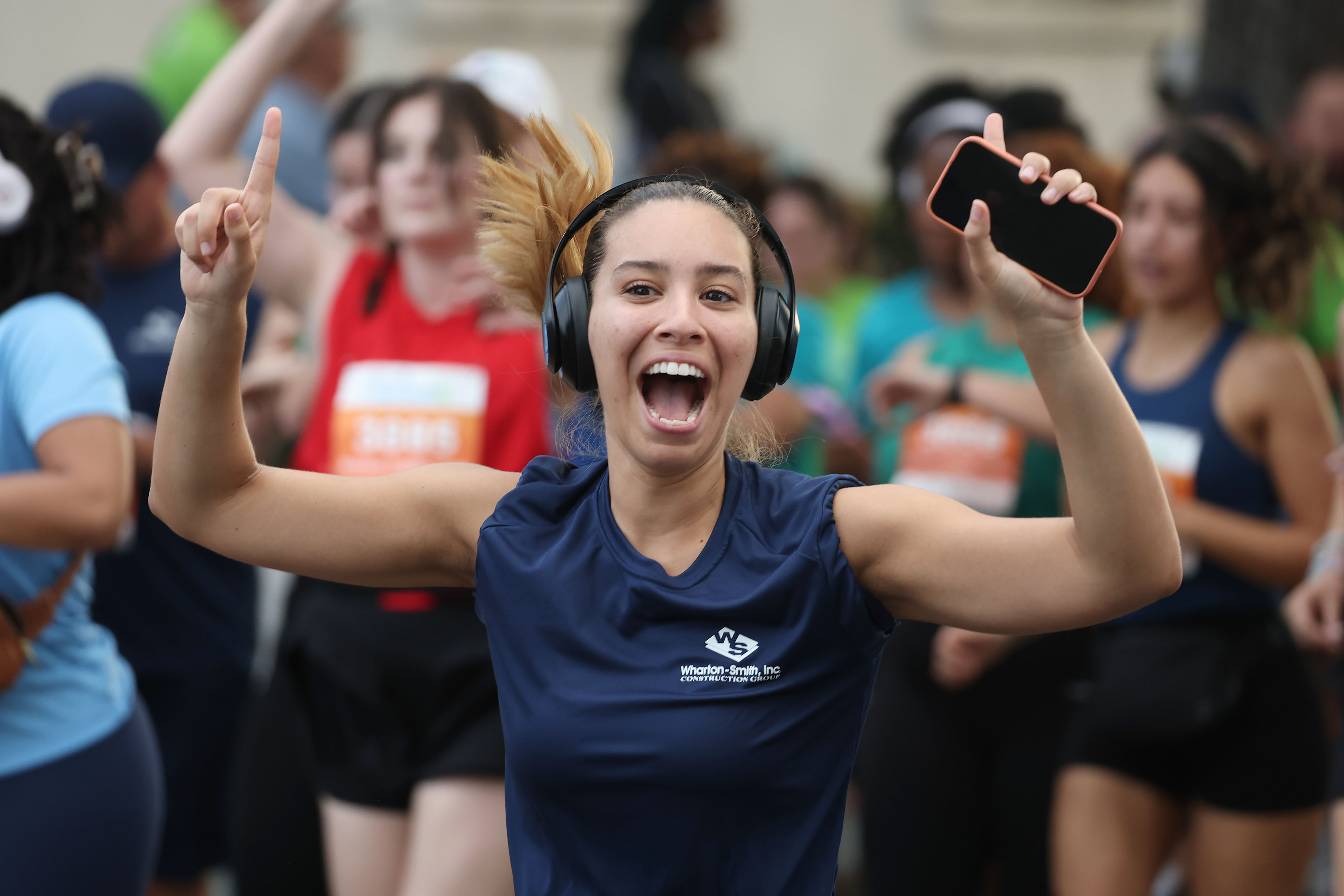A runner cheers during the 32nd AdventHealth Corporate 5K in...
