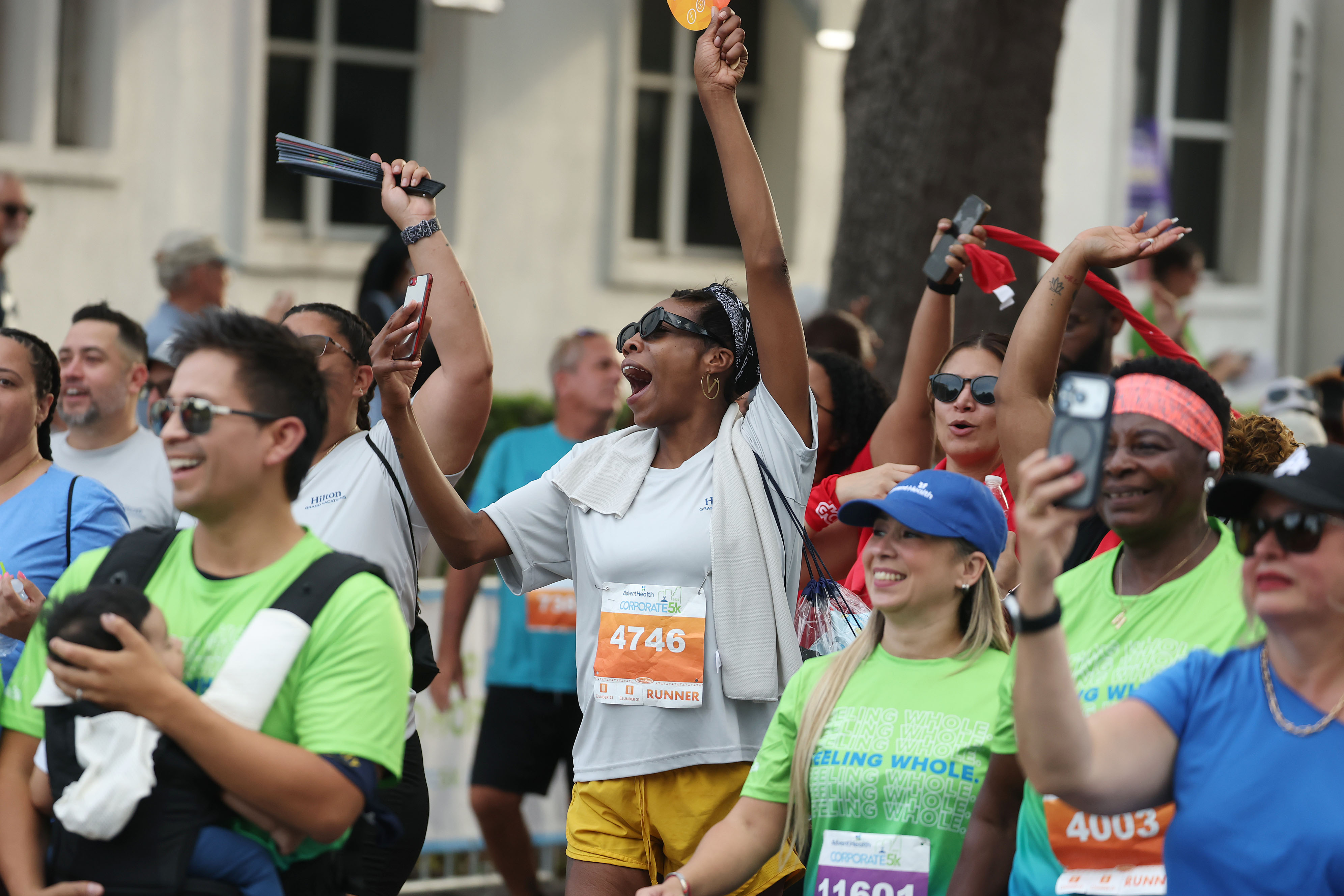 Walkers cheer during the 32nd AdventHealth Corporate 5K in downtown...