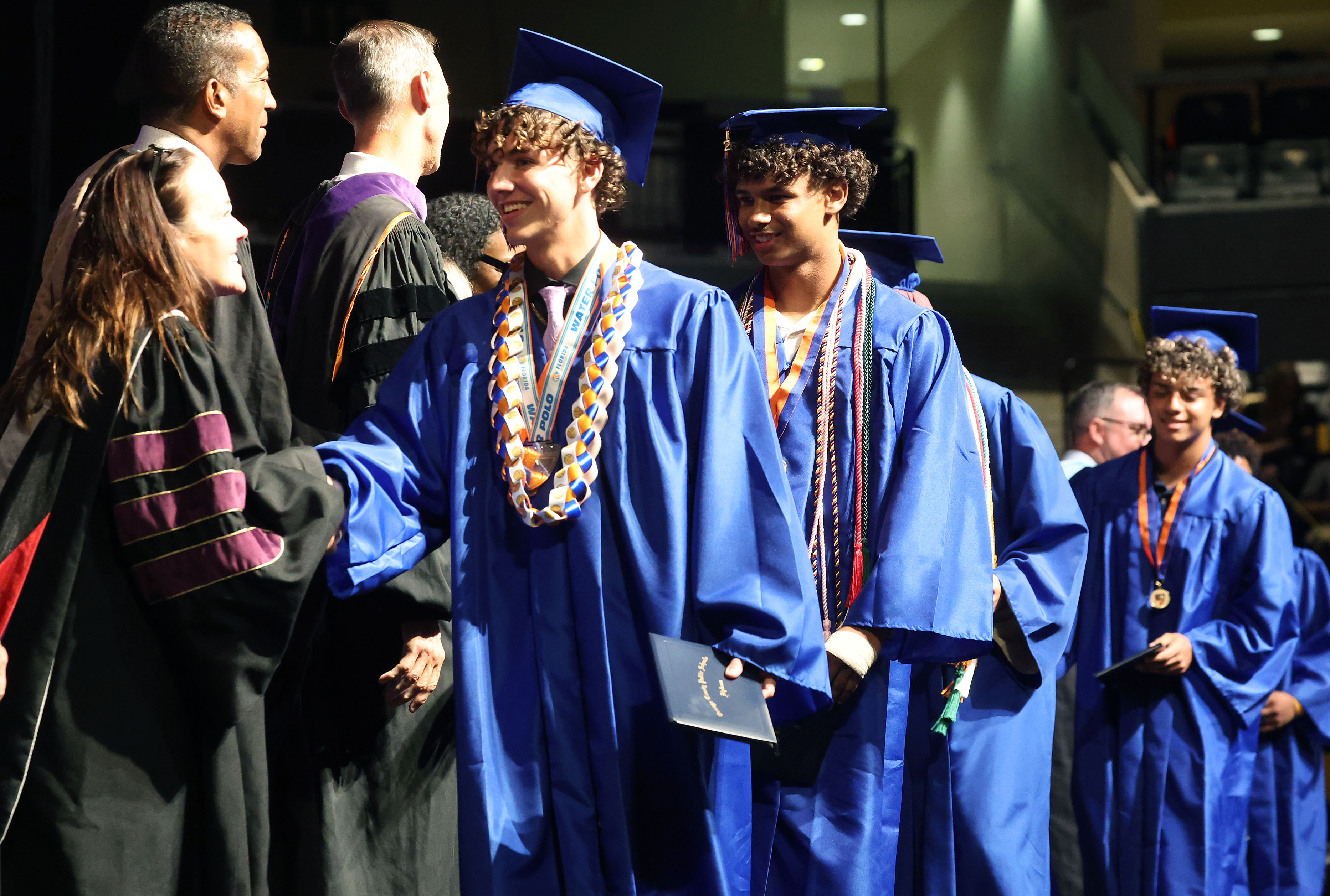 Graduates receive their diplomas during West Orange High School commencement...