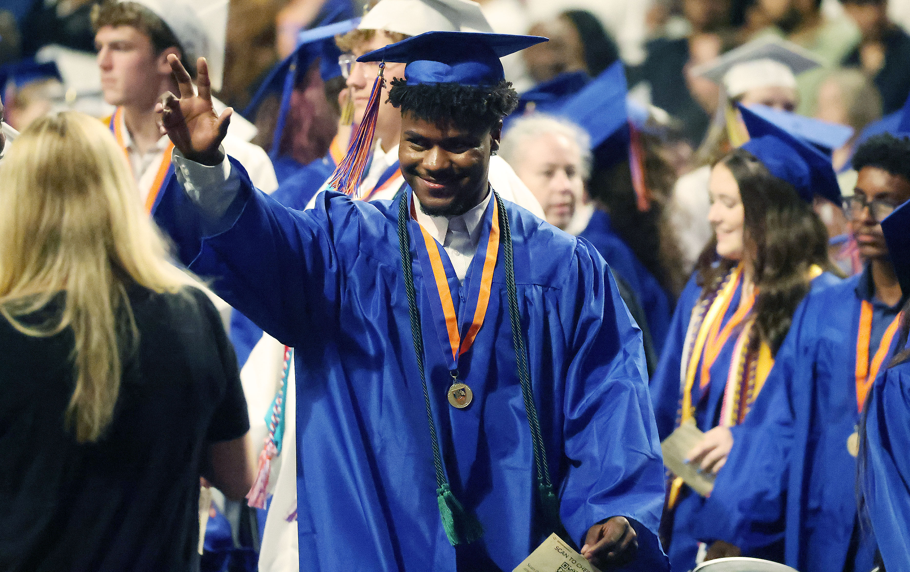 A graduate waves to family during West Orange High School...