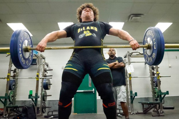 DeLand High weightlifter Peyton McKenzie works with his coach, Damian Dunn, during a training session at DeLand High School on Monday, May 4, 2026. (Rich Pope/Orlando Sentinel)