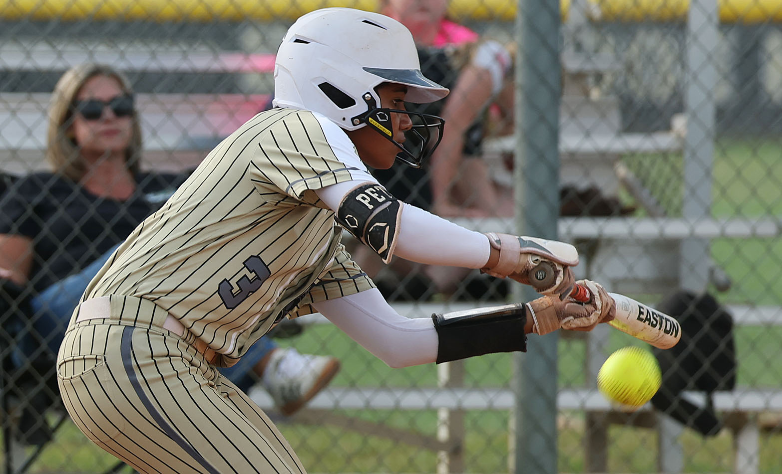 East Ridge High softball player Veronica Peterson bunts during the...