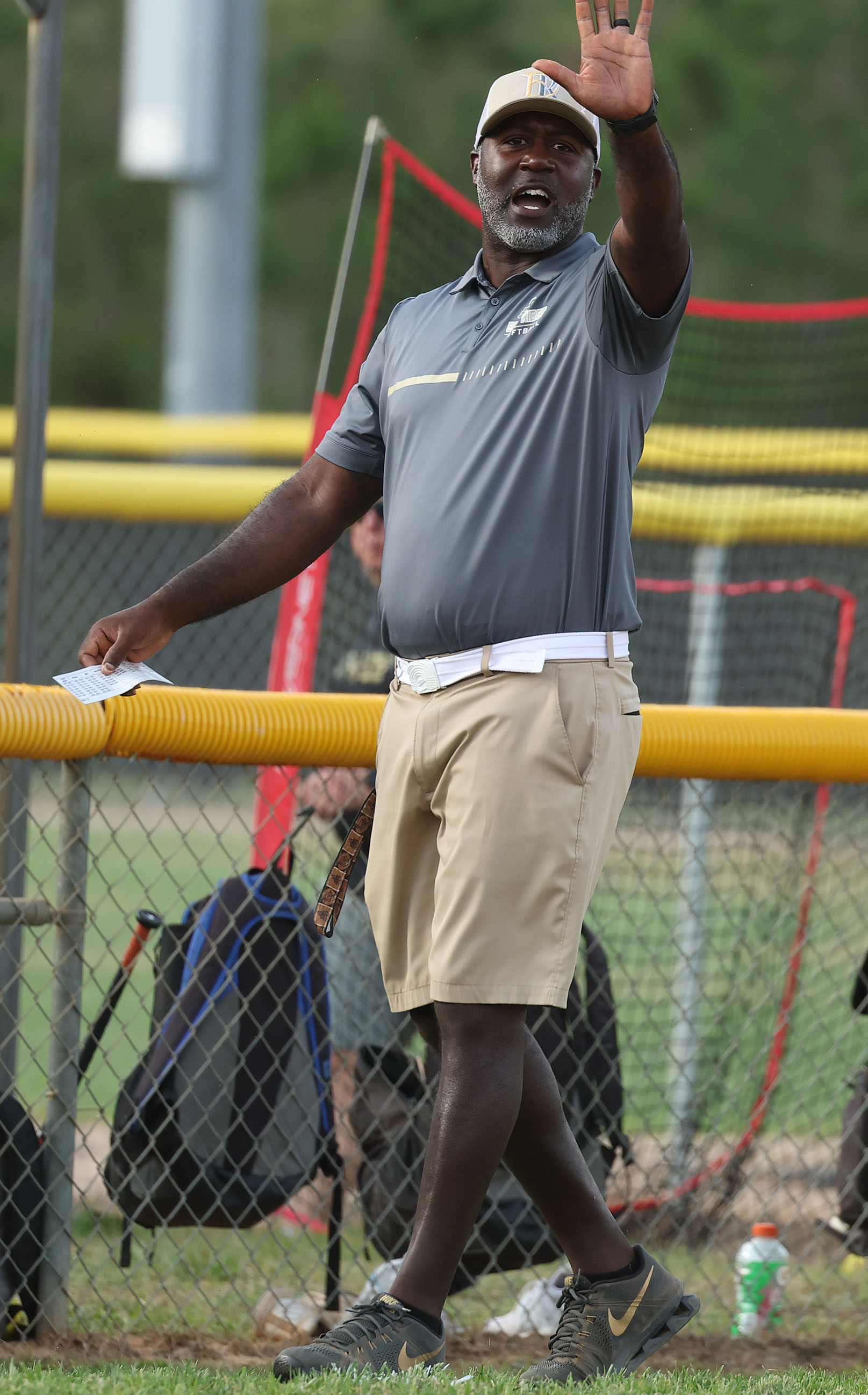 East Ridge High softball coach Al Peterson signals during the...