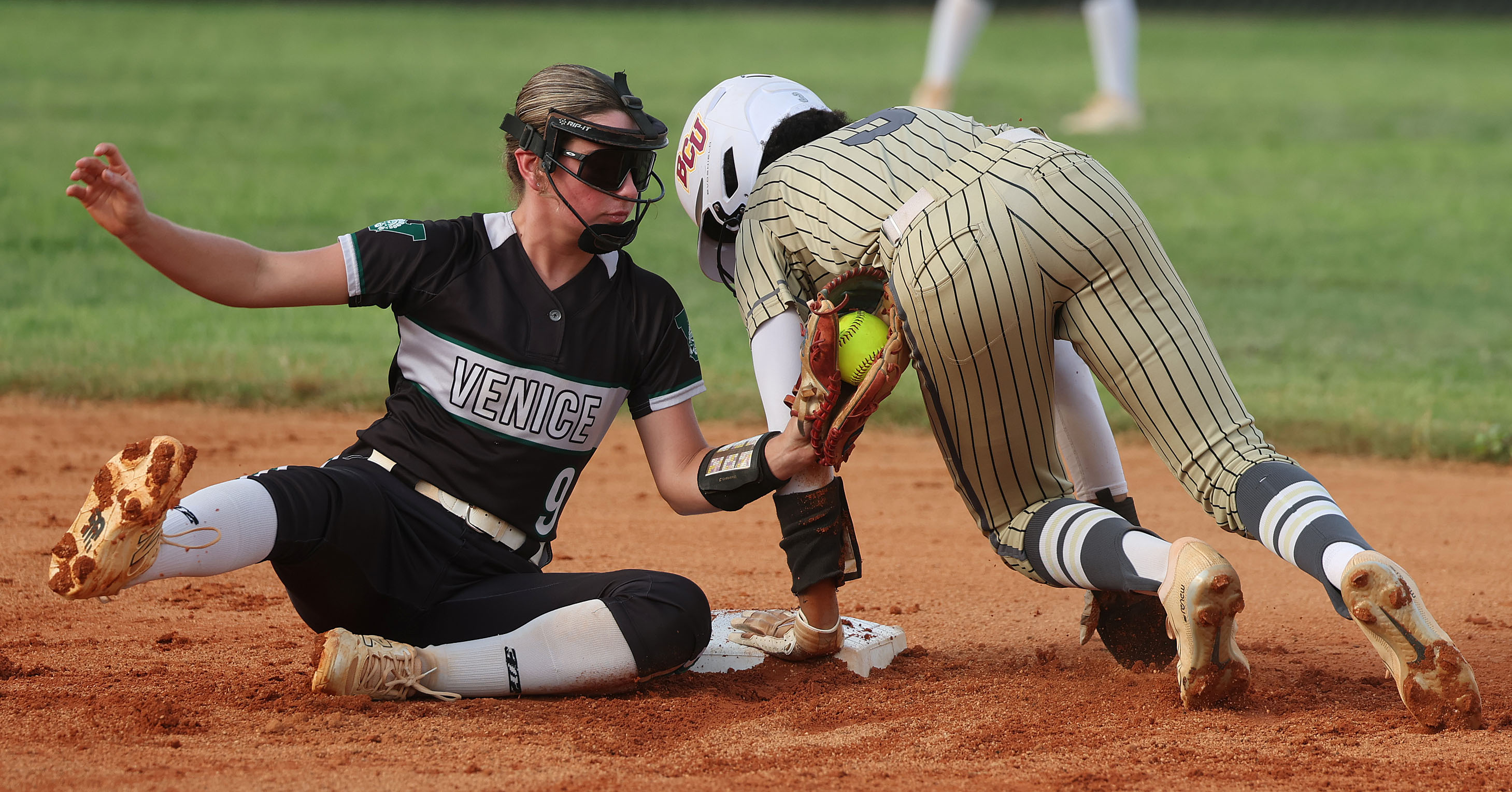 East Ridge High softball player Veronica Peterson (3) holds on...