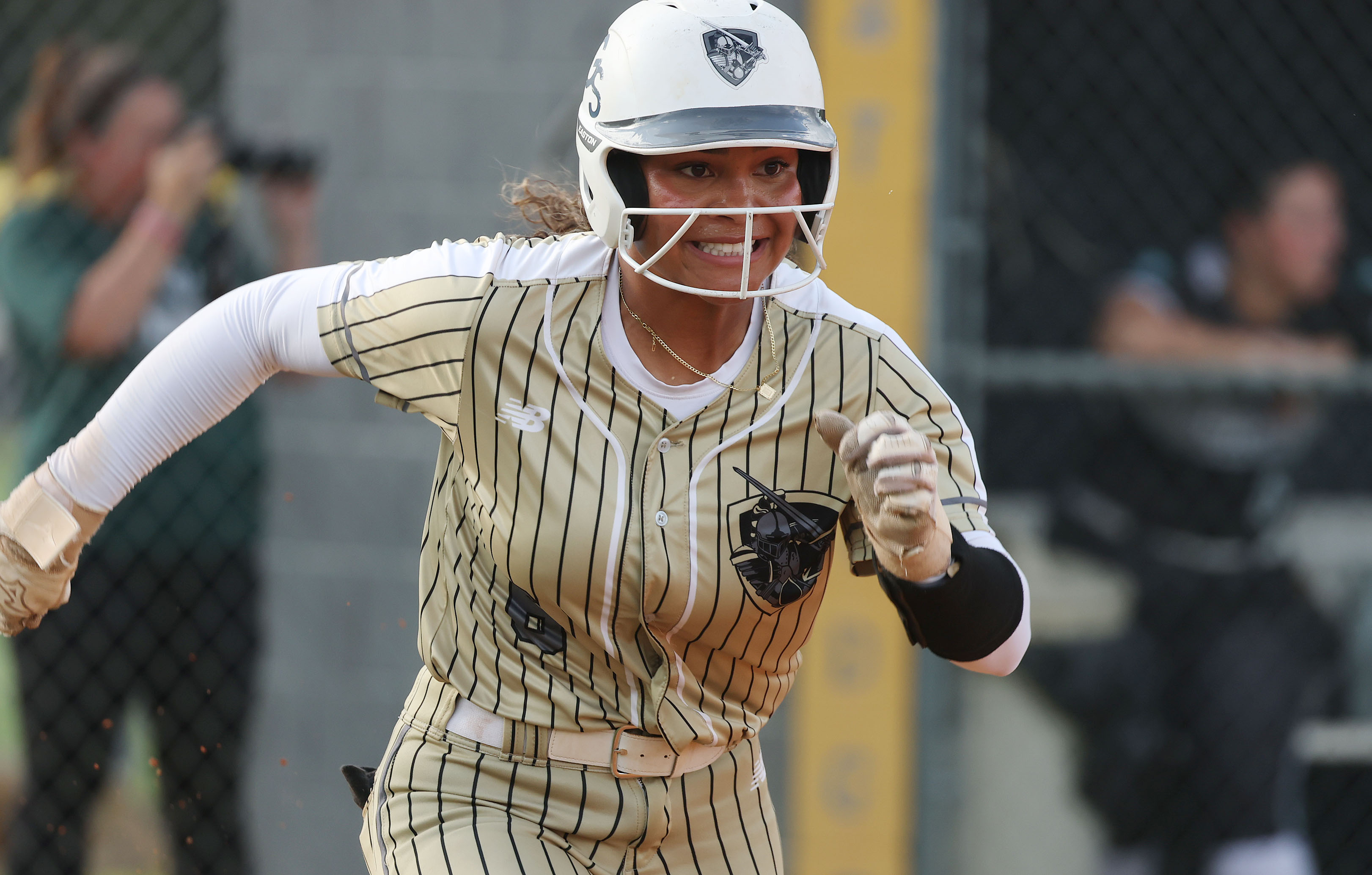 East Ridge High softball player Lelia Bolden happily runs to...