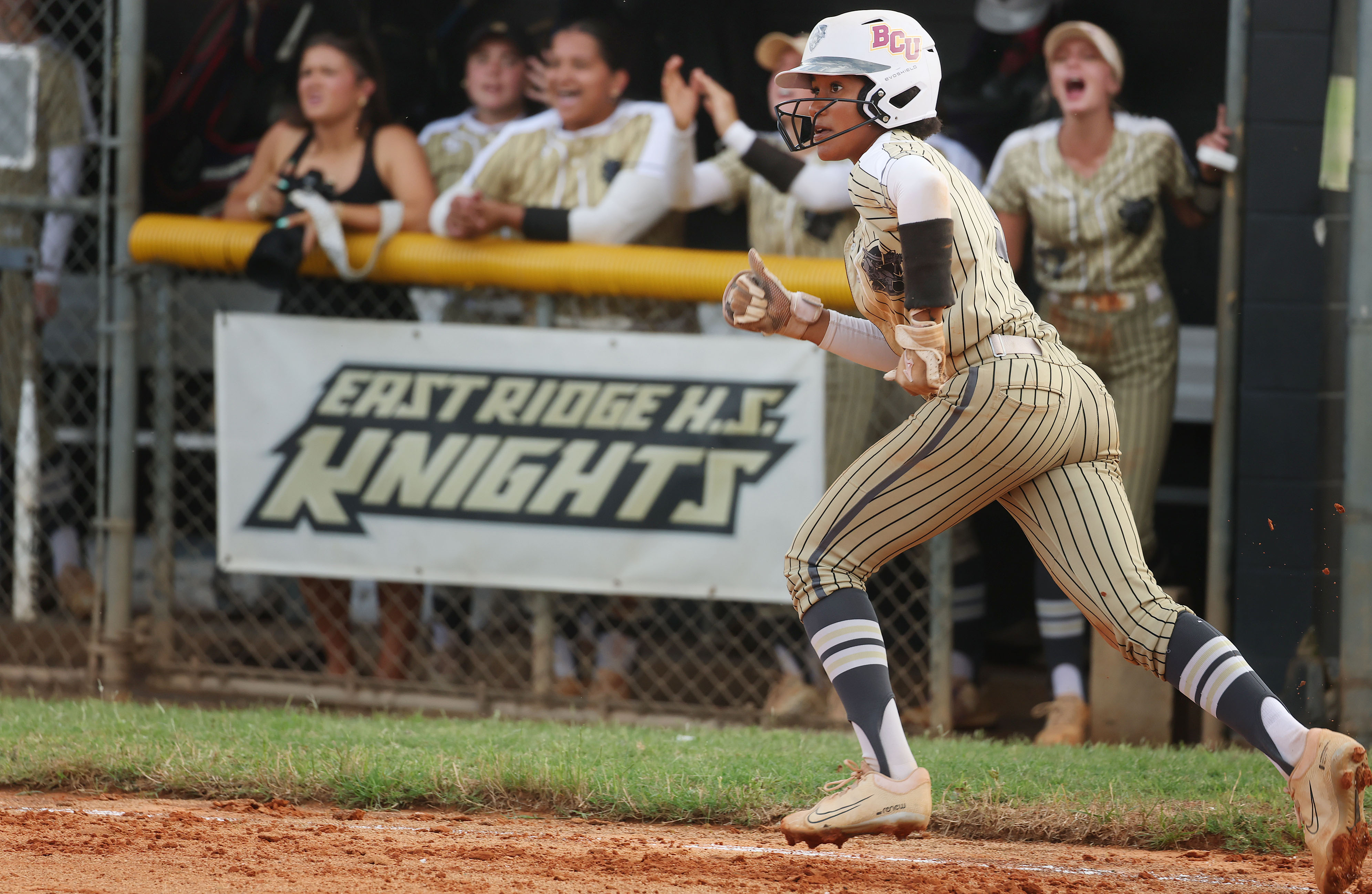 East Ridge High softball player Victoria Peterson runs after a...