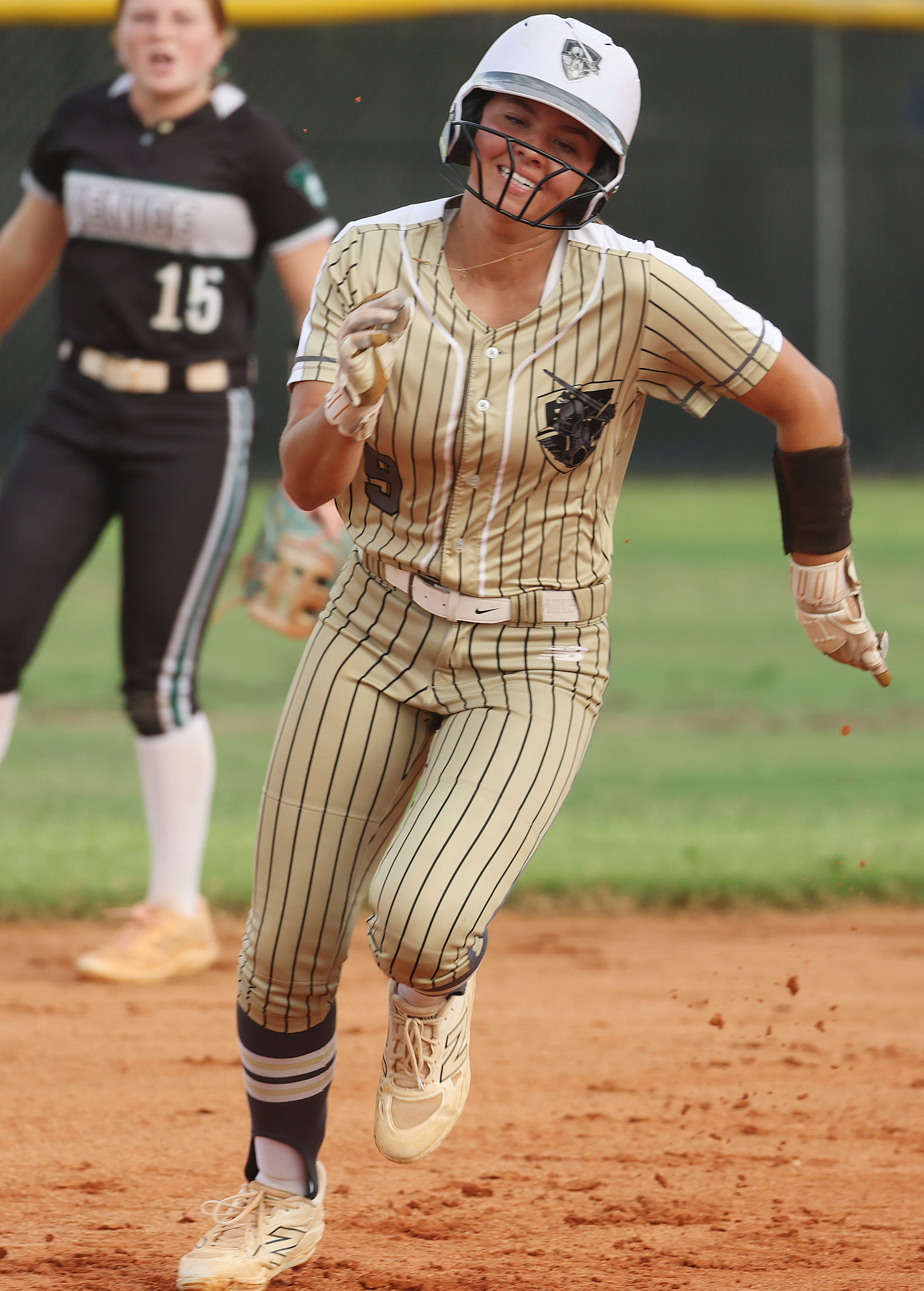 East Ridge High softball player Bailey Page smiles as she...