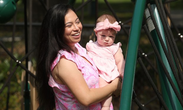 Karen Anthony holds her infant daughter Selena at Minnehaha Park in Maitland on Thursday, May 21, 2026. (Stephen M. Dowell/Orlando Sentinel)
