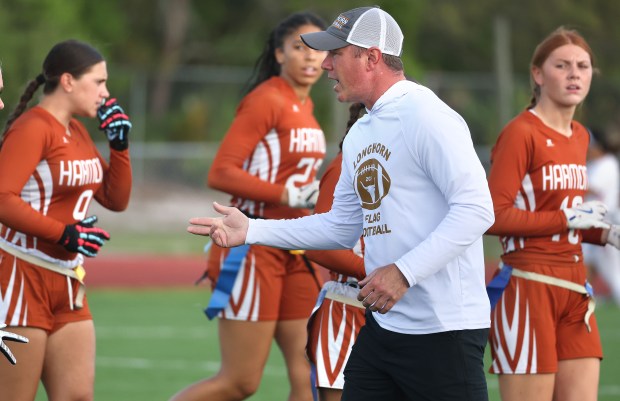 Harmony High flag football coach Paul Strauch coaches during the Centennial High at Harmony High game in St. Cloud on Friday, April 10, 2026. (Stephen M. Dowell/Orlando Sentinel)