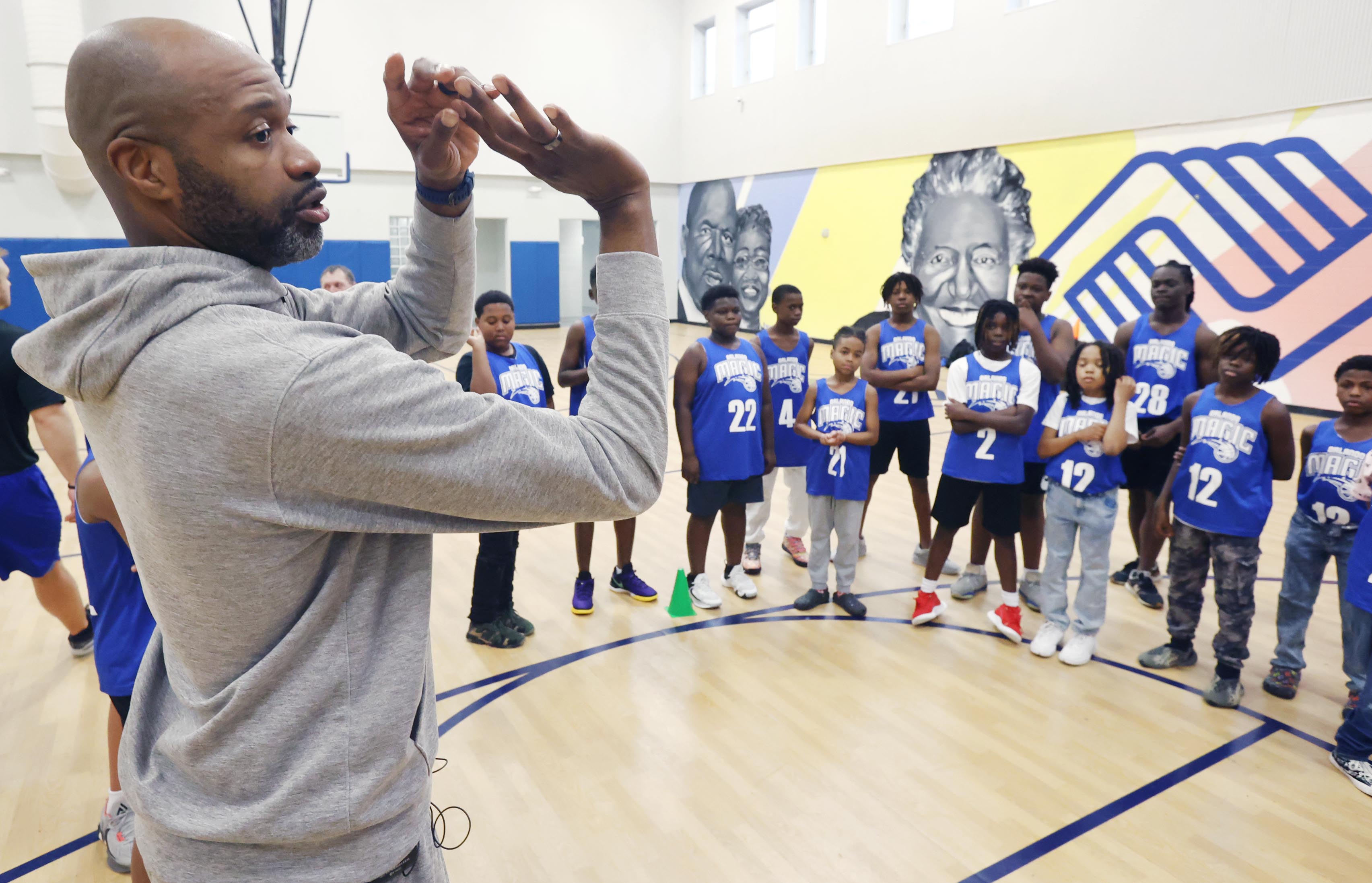 Orlando Magic head coach Jamahl Mosley gives kids basketball pointers...