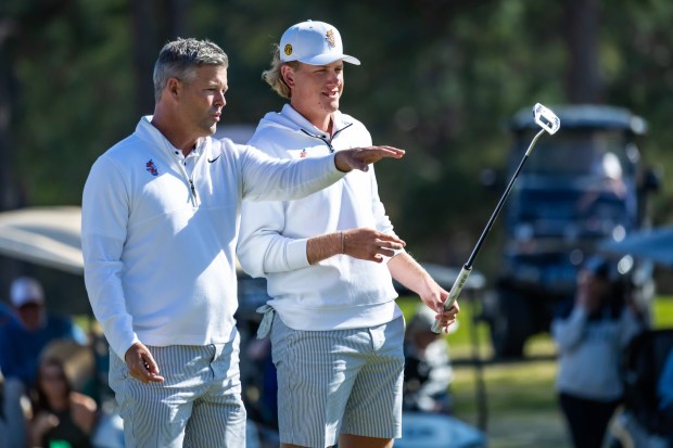 UF golfer Luke Poulter (right) and coach JC Deacon discuss strategy during Poulter's victory at the 45th annual Schenkel Invitational during the 2025 season. (Photograph by AJ Henderson / Georgia Southern Athletics)