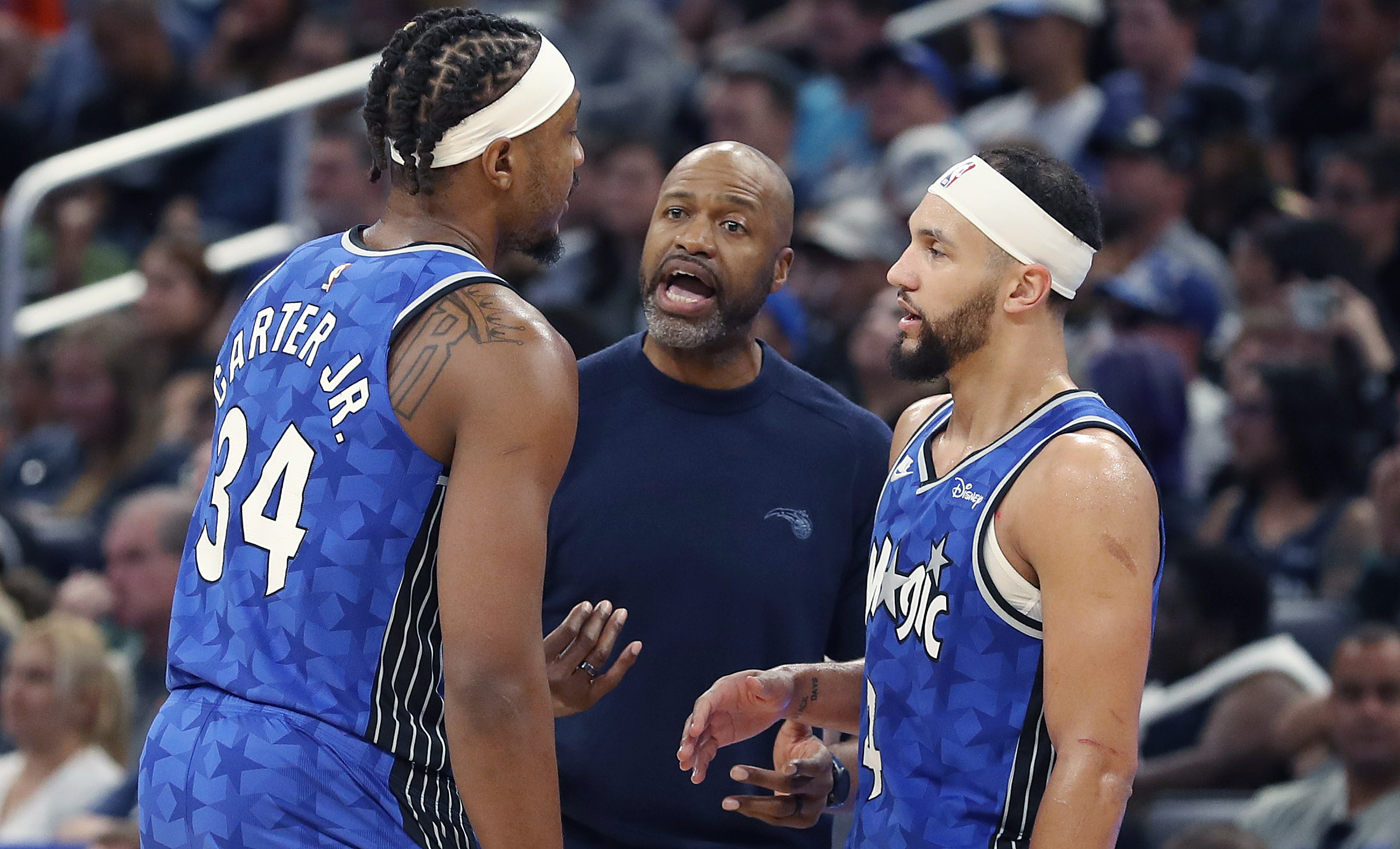 Orlando coach Jamahl Mosley coaches players Wendell Carter Jr. (left)...