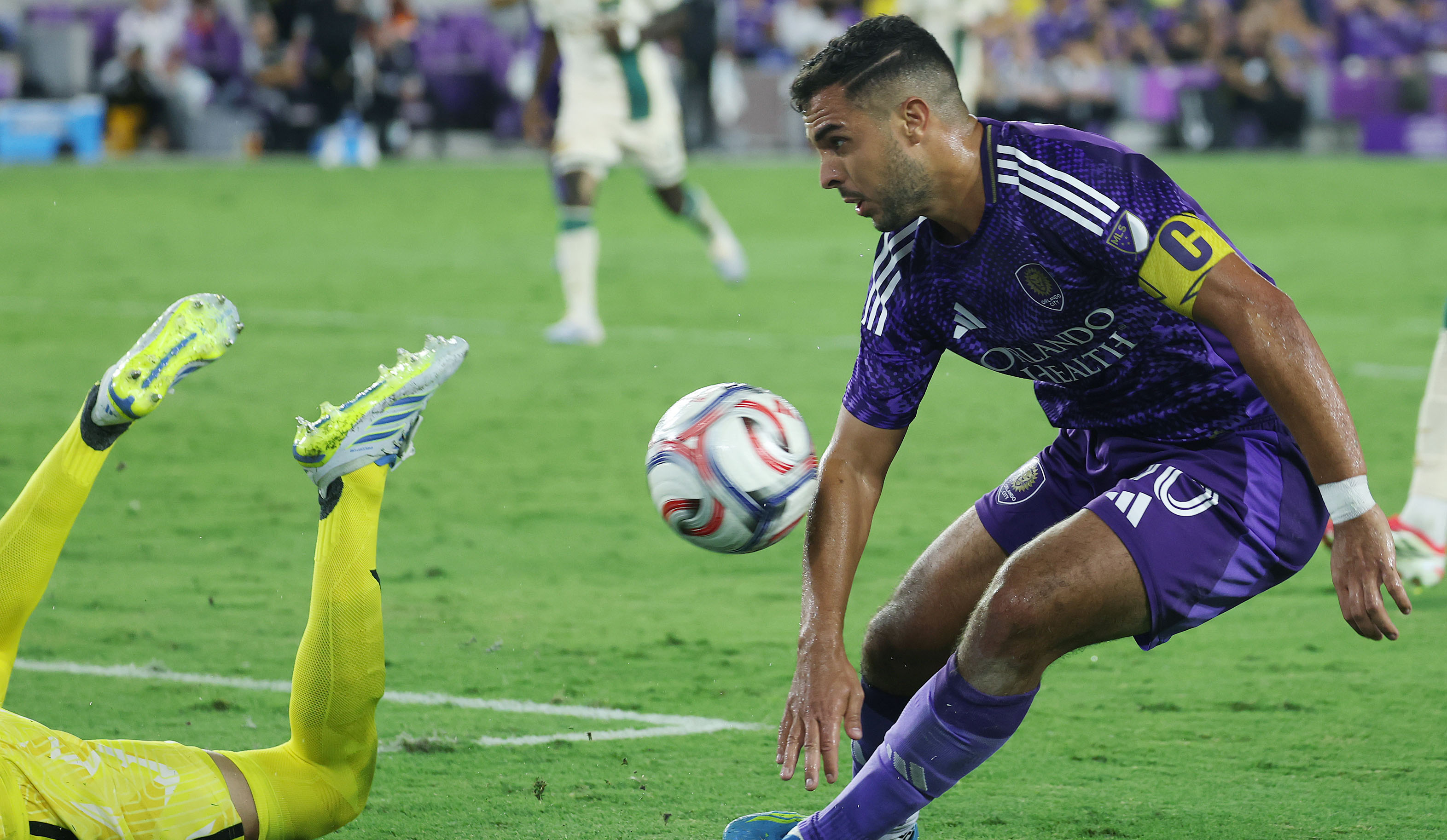Orlando player Martin Ojeda (right) can't quite get the ball...