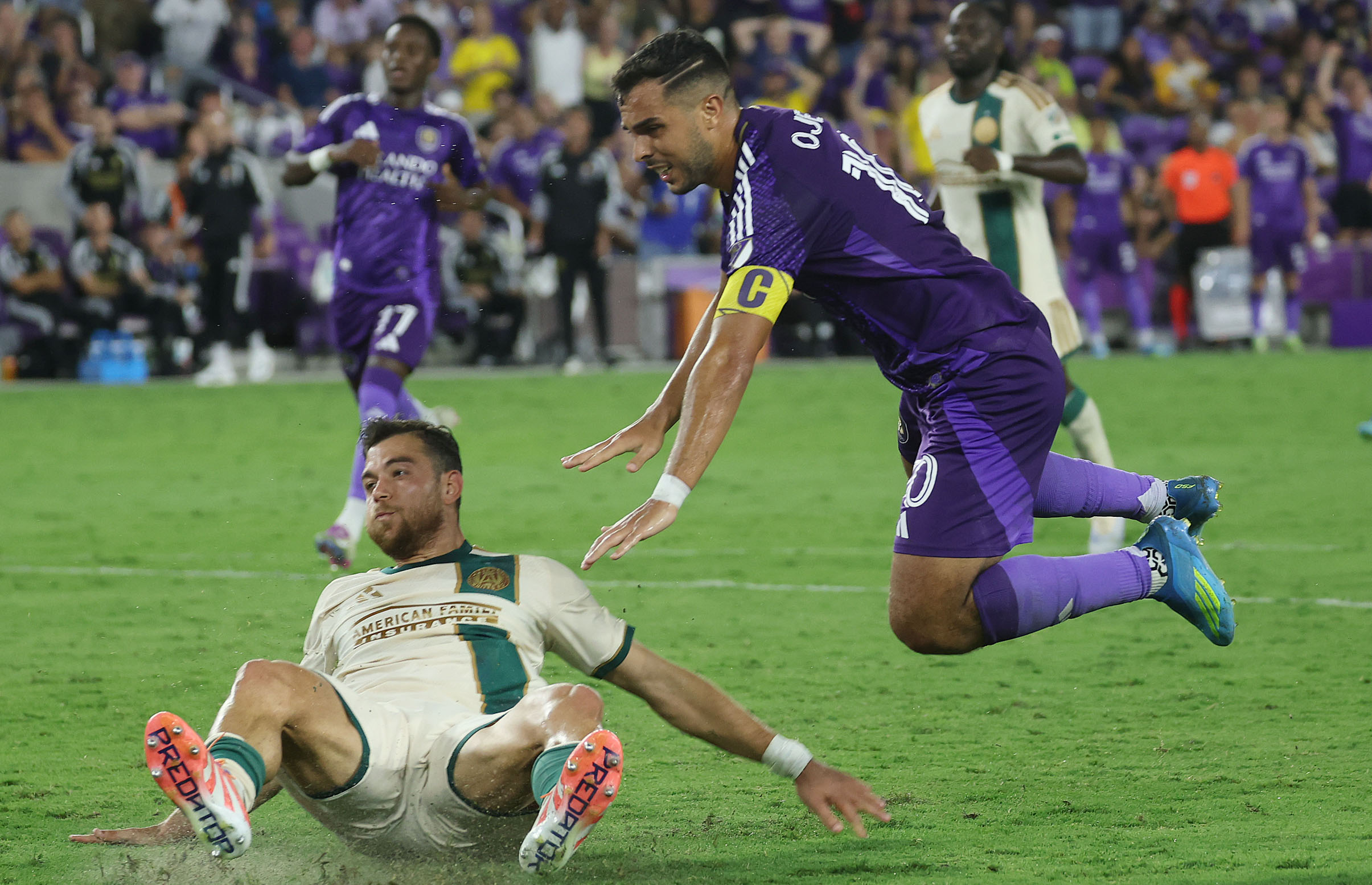 Orlando player Martin Ojeda (top) leaps during the Atlanta United...