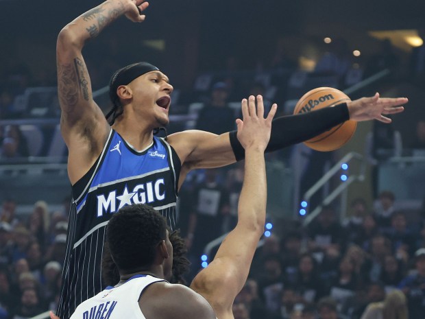 Orlando forward Paolo Banchero (top) leaps over Detroit center Jalen Duren (0) during the Detroit Pistons at Orlando Magic game 6 of the NBA Playoffs at the Kia Center in Orlando on Friday, May 1, 2026. (Stephen M. Dowell/Orlando Sentinel)