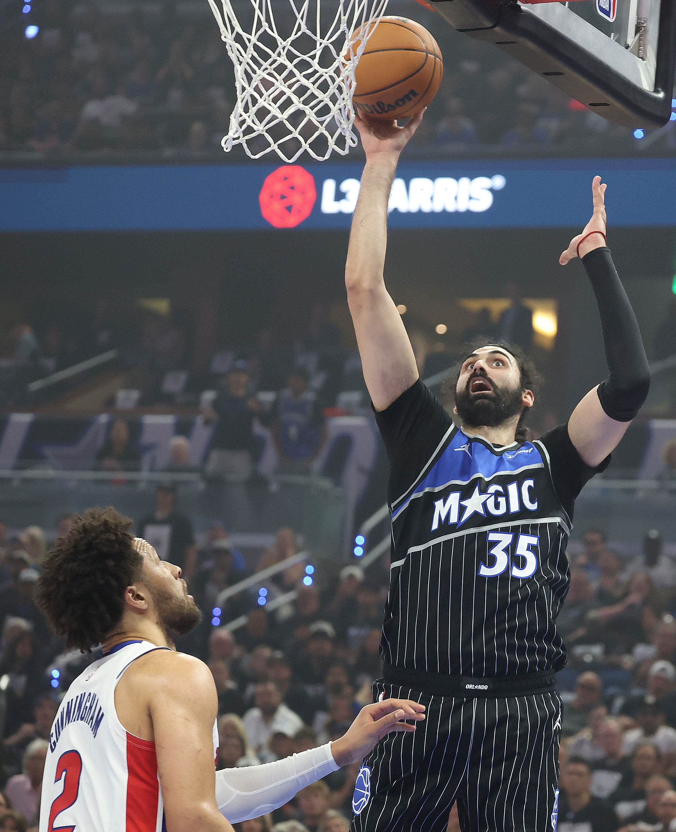 Orlando center Goga Bitadze (35) scores over Detroit guard Cade...