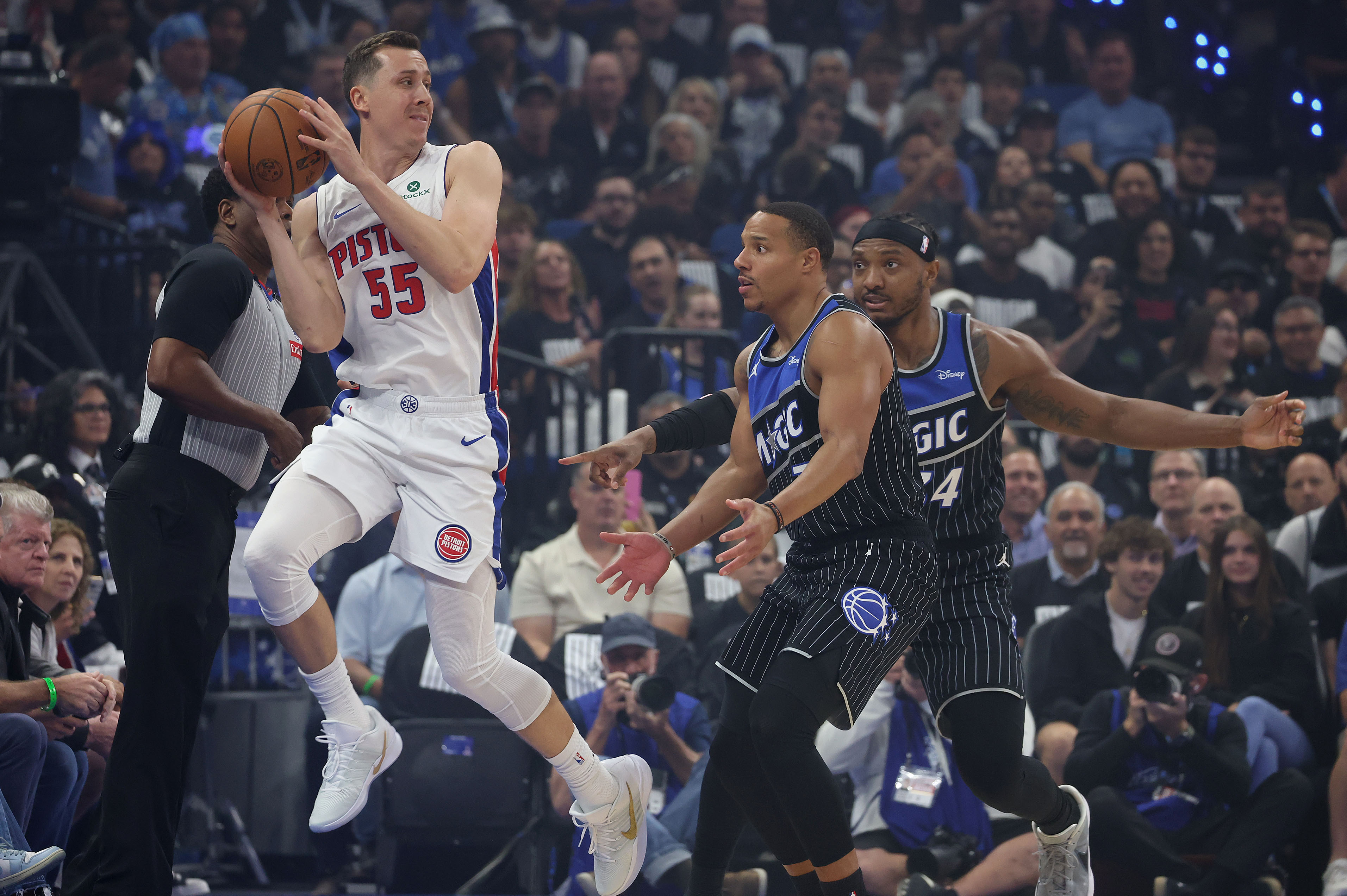 Detroit guard Duncan Robinson (55) leaps to control the ball...