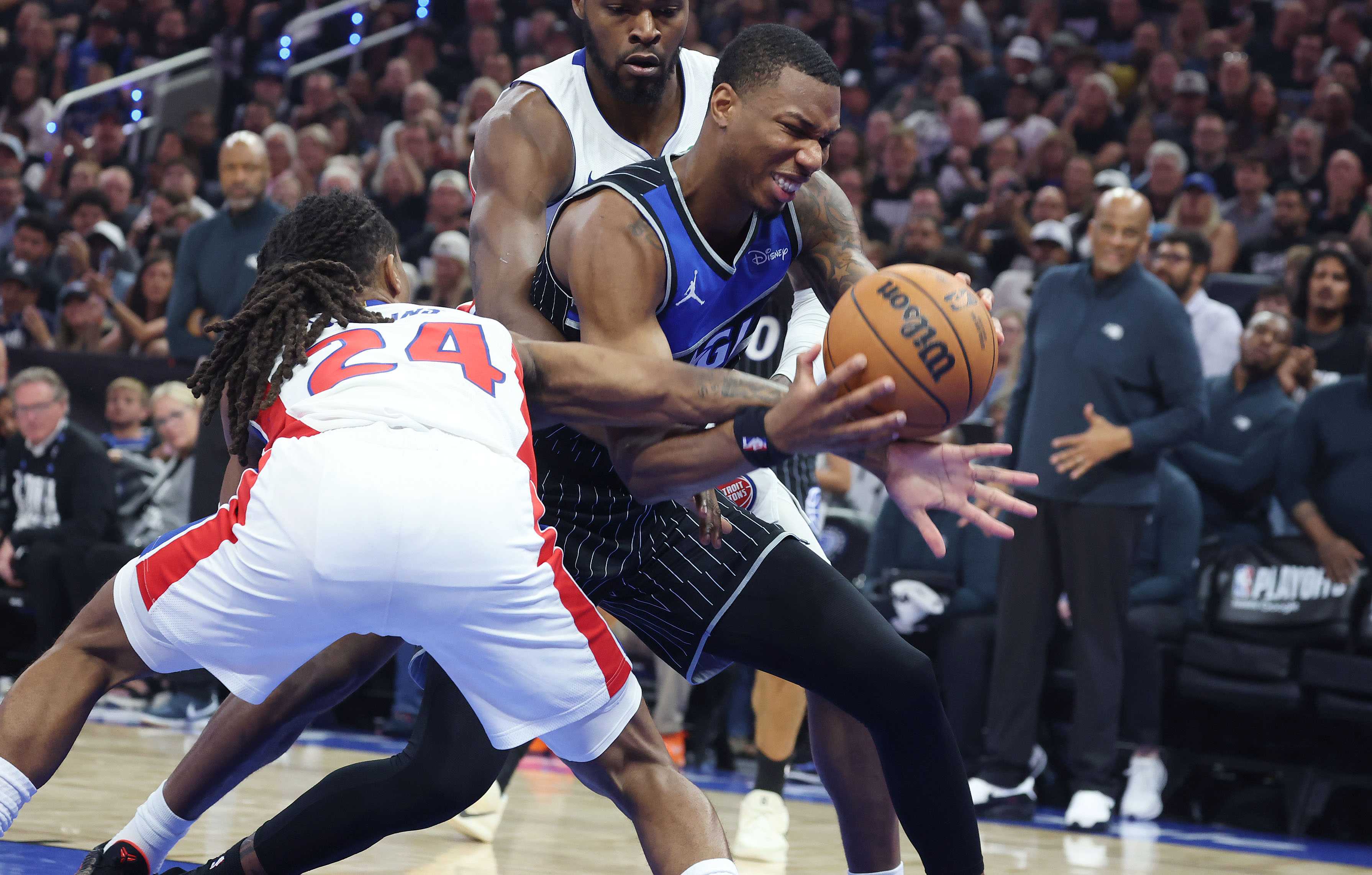 Orlando forward Jamal Cain (right) can't get past Detroit guard...