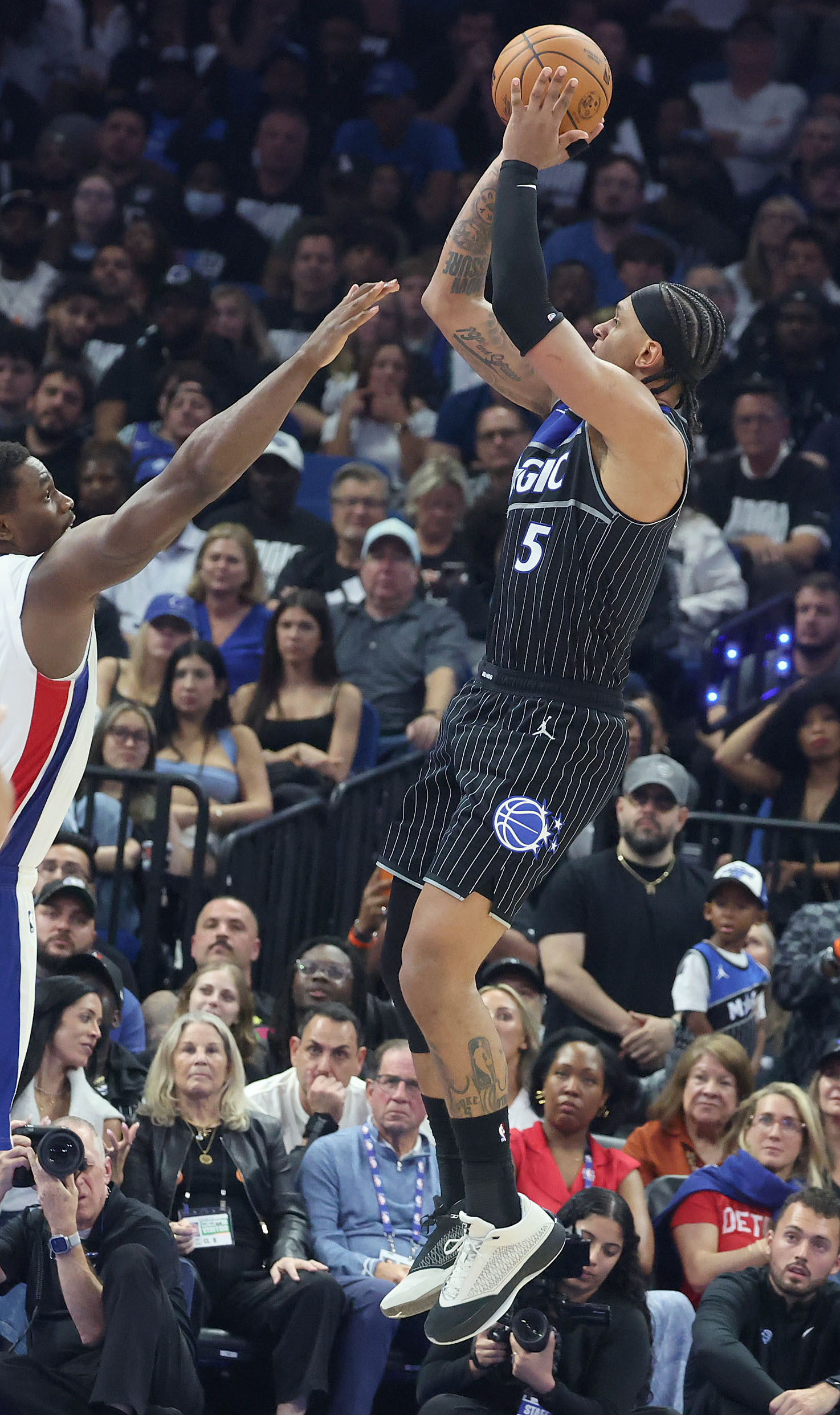 Orlando forward Paolo Banchero (5) shoots a three point shot...