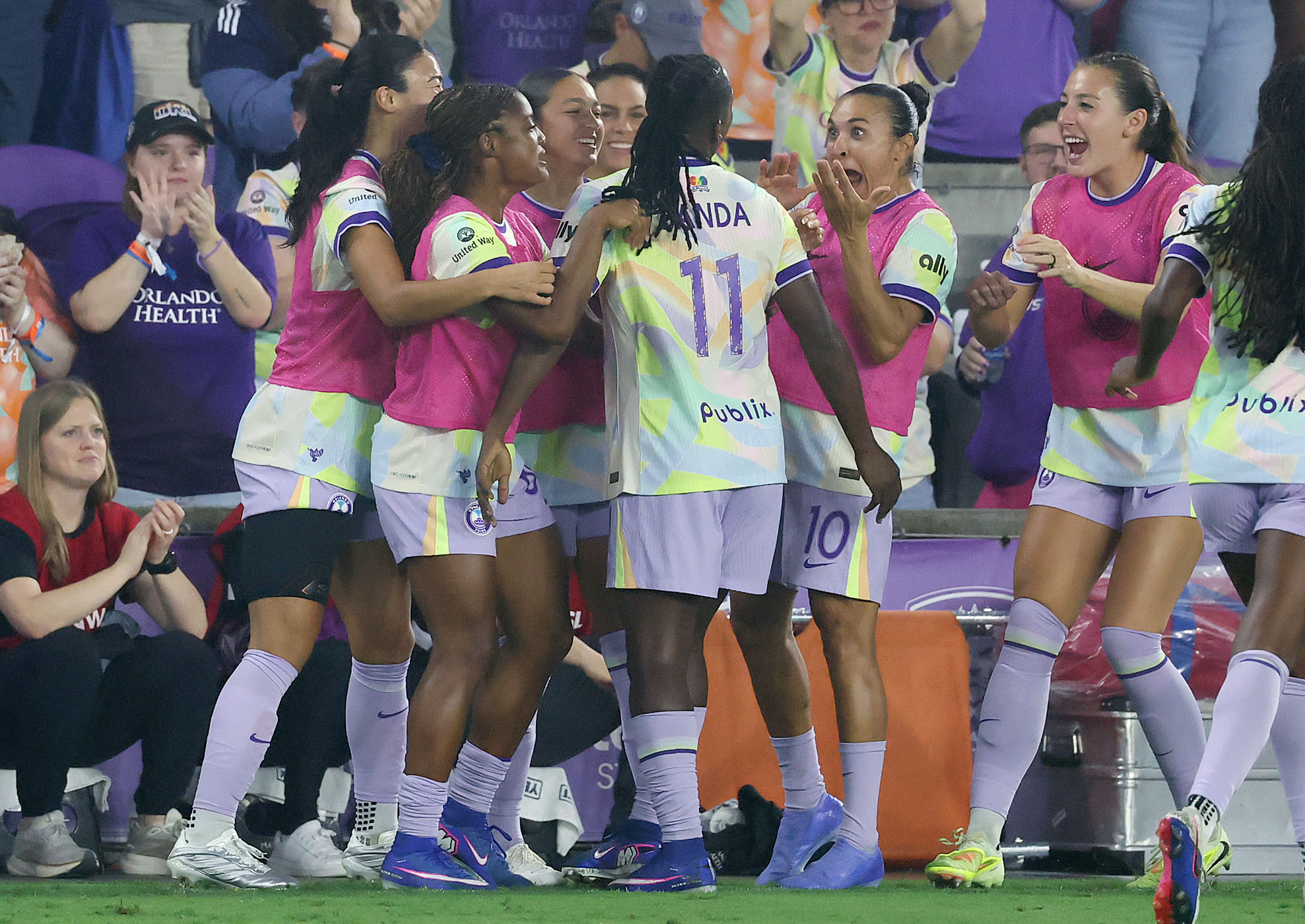 Orlando players celebrate with Barbra Banda (11) after she scored...
