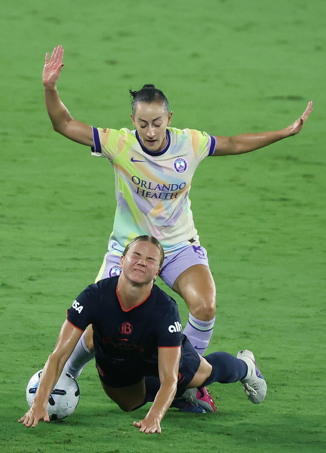 Orlando player Luana (top) runs over Bay FC player Claire...
