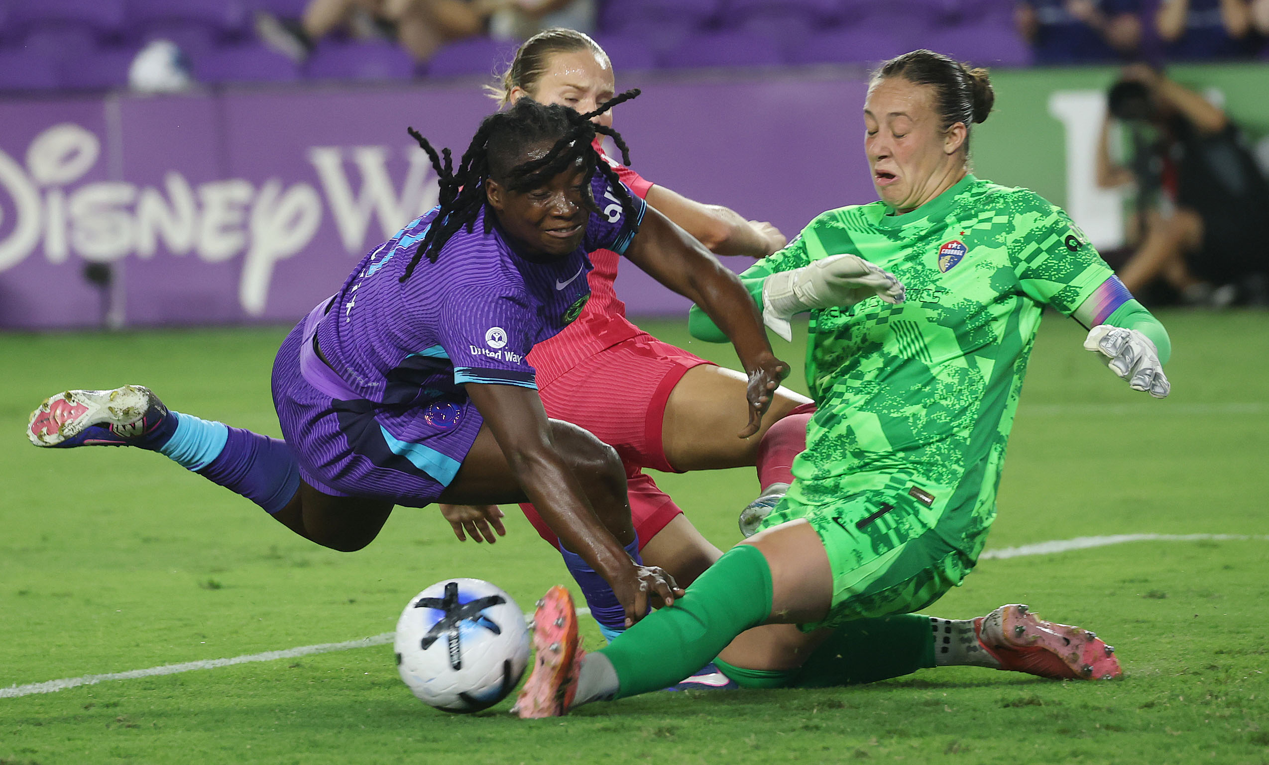 North Carolina goalkeeper Kailen Sheridan (right) stops a goal attempt...