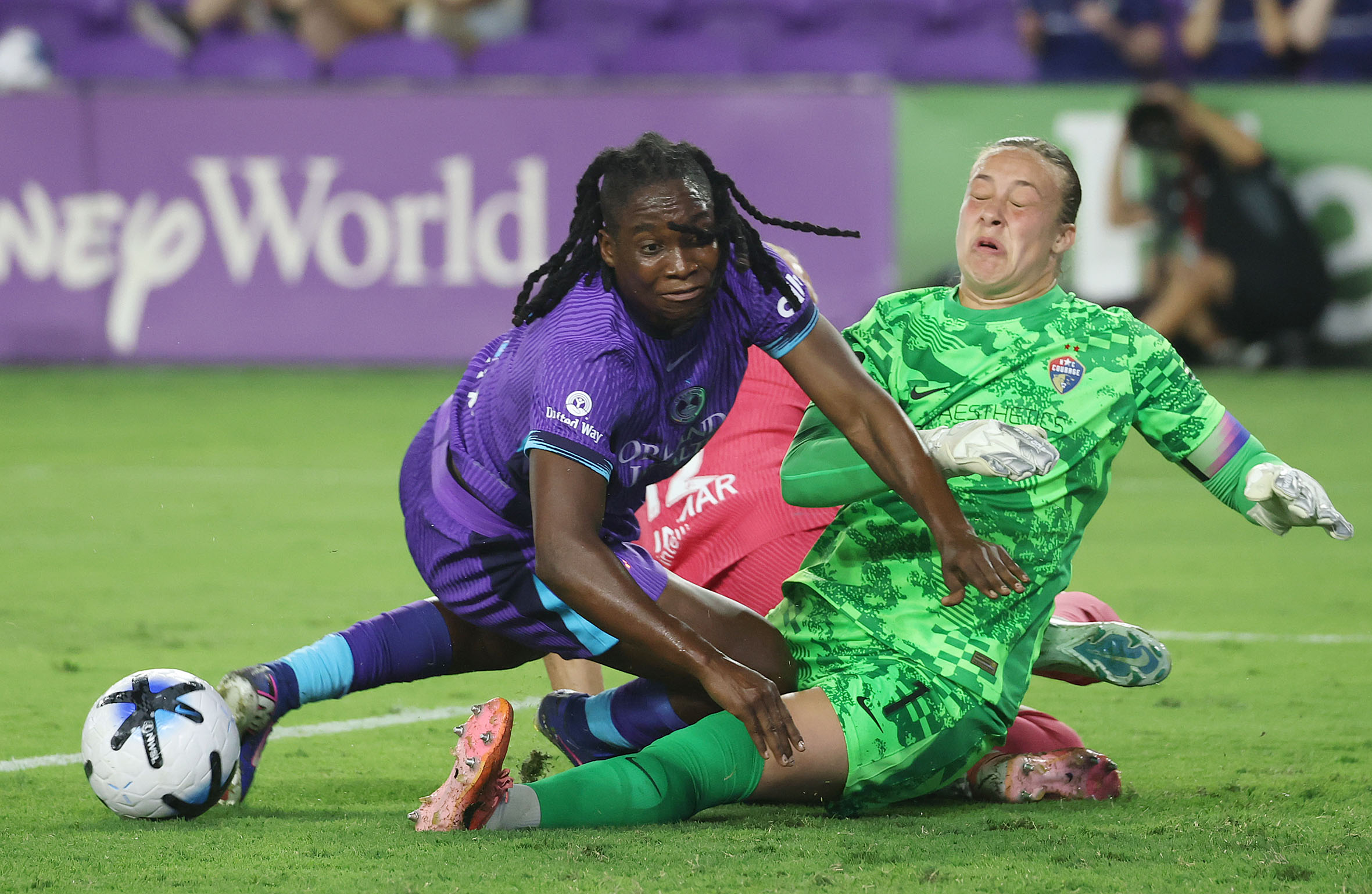 Orlando player Barbra Banda (left) collides with North Carolina goalkeeper...