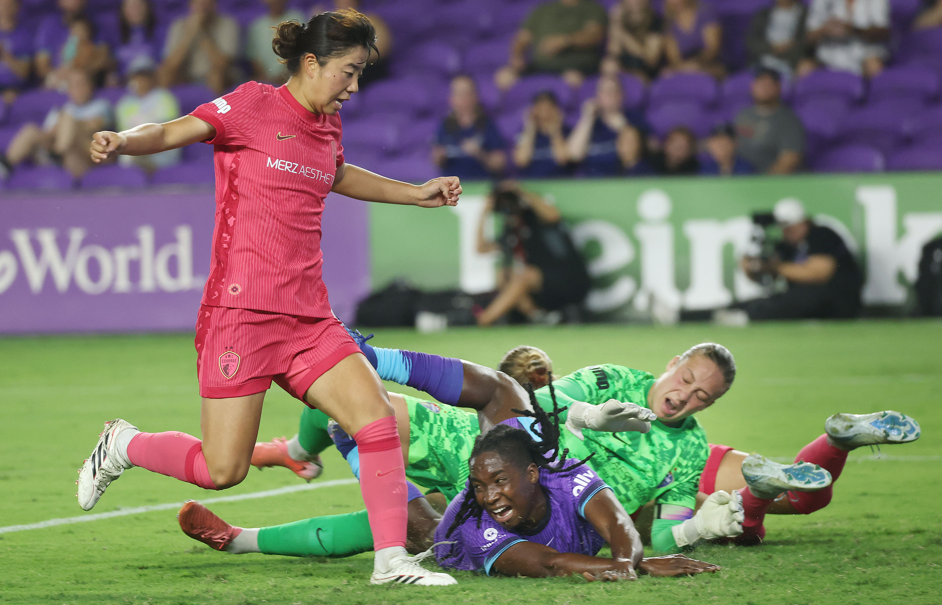 Orlando player Barbra Banda (middle) collides with North Carolina goalkeeper...