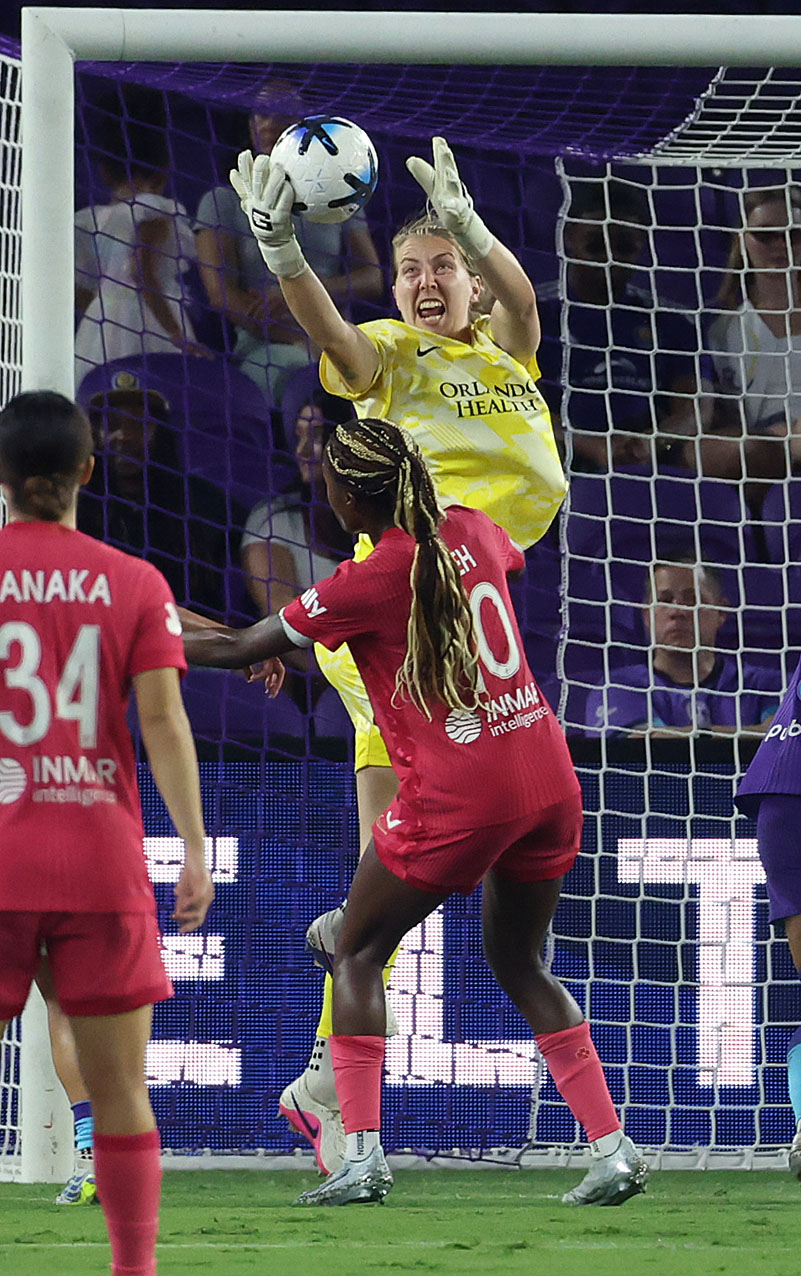 Orlando goalkeeper Anna Moorhouse (top) makes a save during the...
