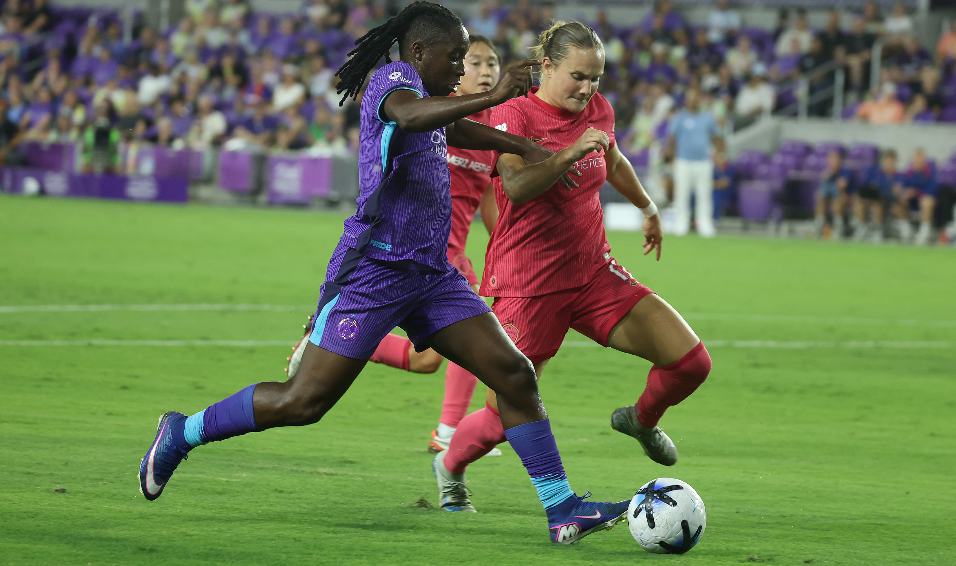 Orlando player Barbra Banda (left) controls the ball beside North...