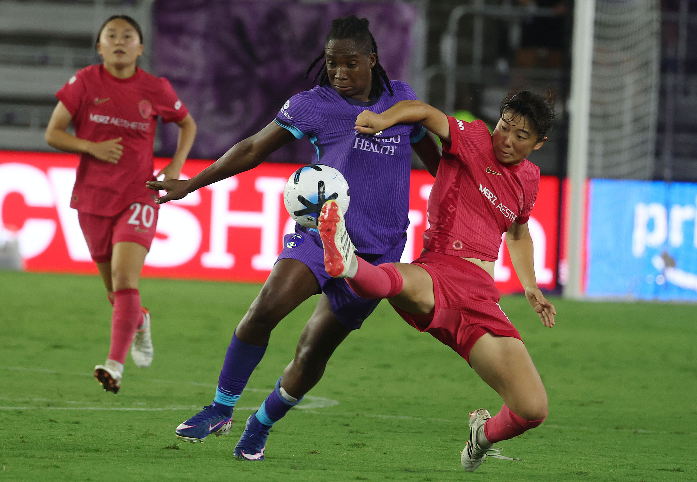 Orlando player Barbra Banda (middle) battles North Carolina player Uno...
