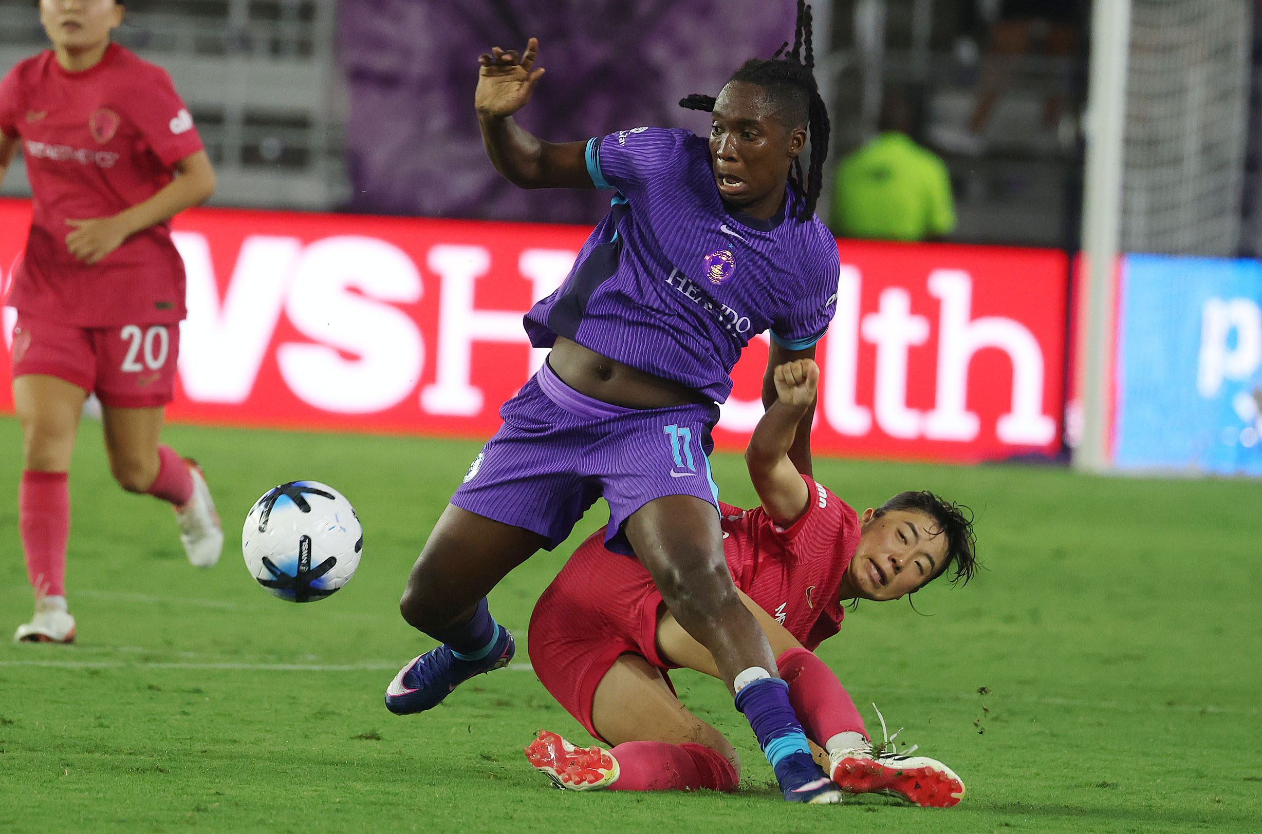 Orlando player Barbra Banda (11) runs over North Carolina player...