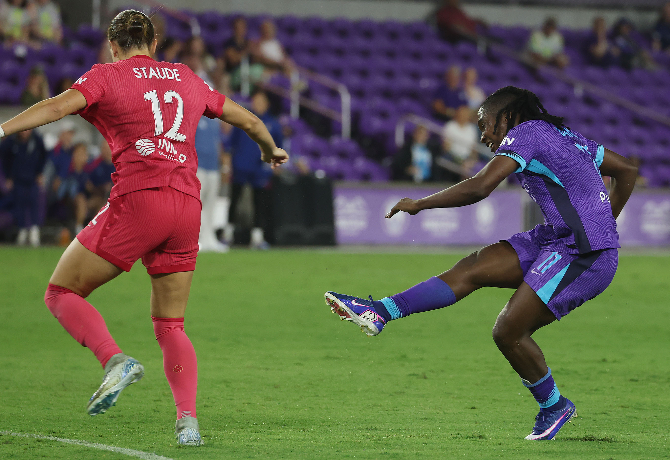 Orlando player Barbra Banda (right) kicks at goal past North...