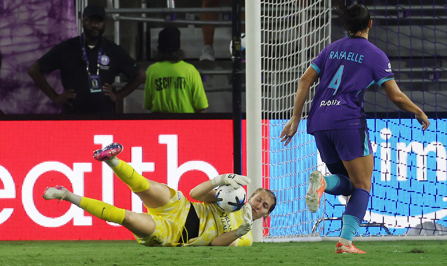 Orlando goalkeeper Anna Moorhouse (bottom) makes a stop beside Orlando...