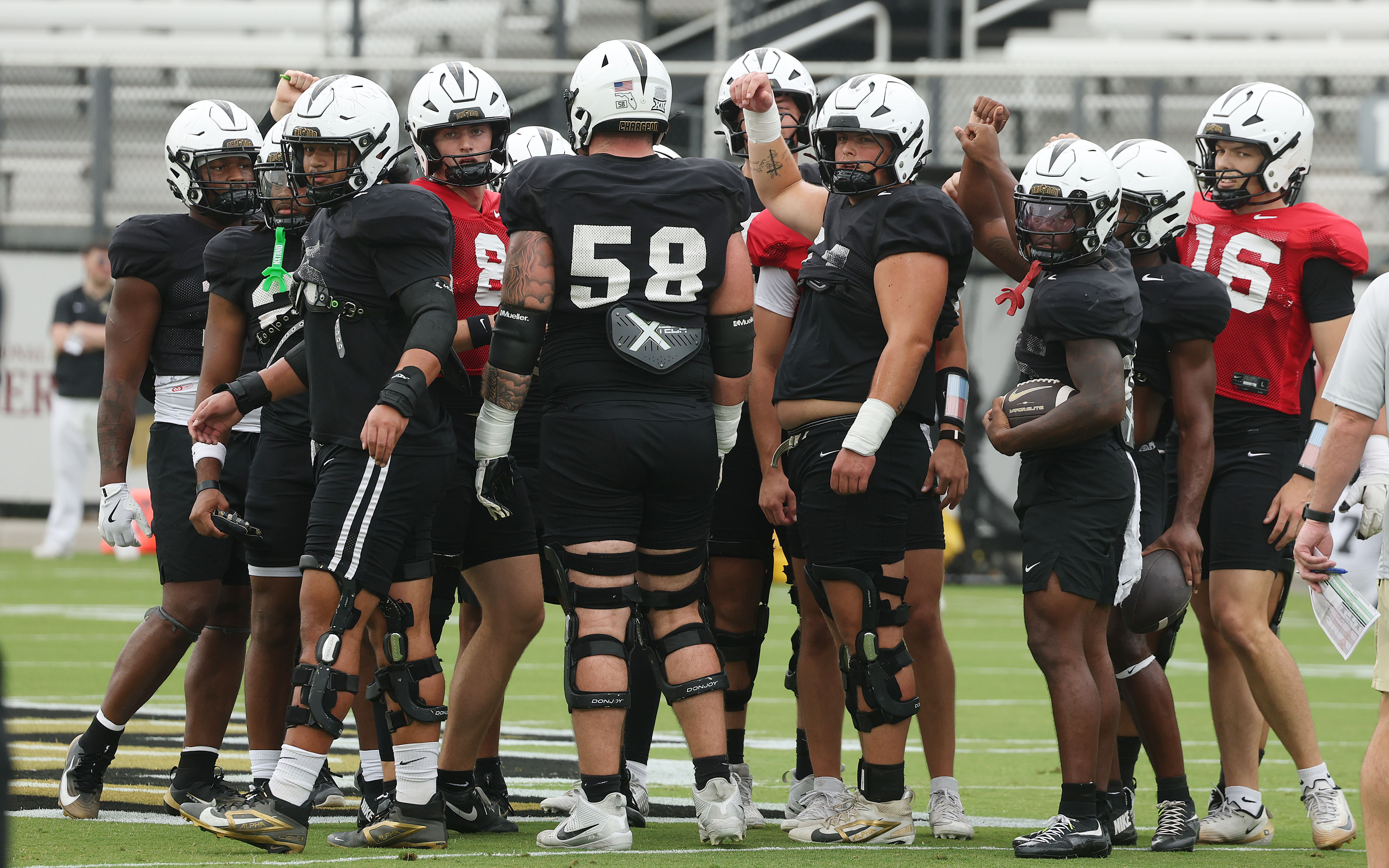 UCF players huddle during UCF Football Open Practice at the...