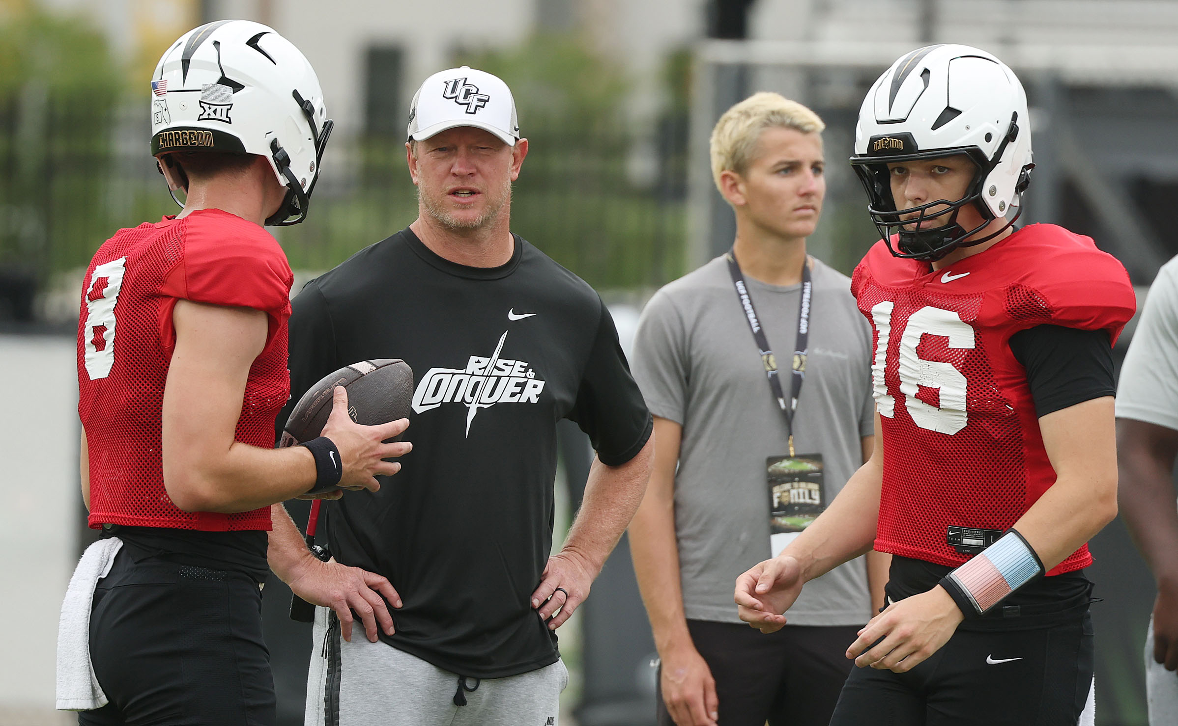 UCF head coach Scott Frost (black shirt) coaches quarterbacks Rocco...