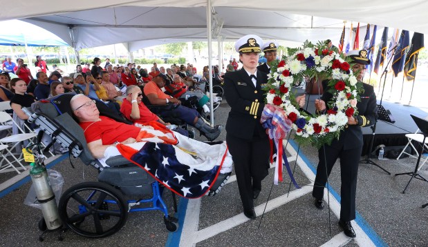 HONORING VETERANS U.S. Army infantry veteran Duane Hunt, left, watches as members of the U.S. Public Health Service present a wreath during the Memorial Day ceremony at the Orlando VA Medical Center in Lake Nona, Friday, May 23, 2025. Hunt served three years in Vietnam. Military leaders and elected officials gathered at the VA for the ceremony with several hundred veterans to kick off the Memorial Day weekend. (Joe Burbank/Orlando Sentinel)