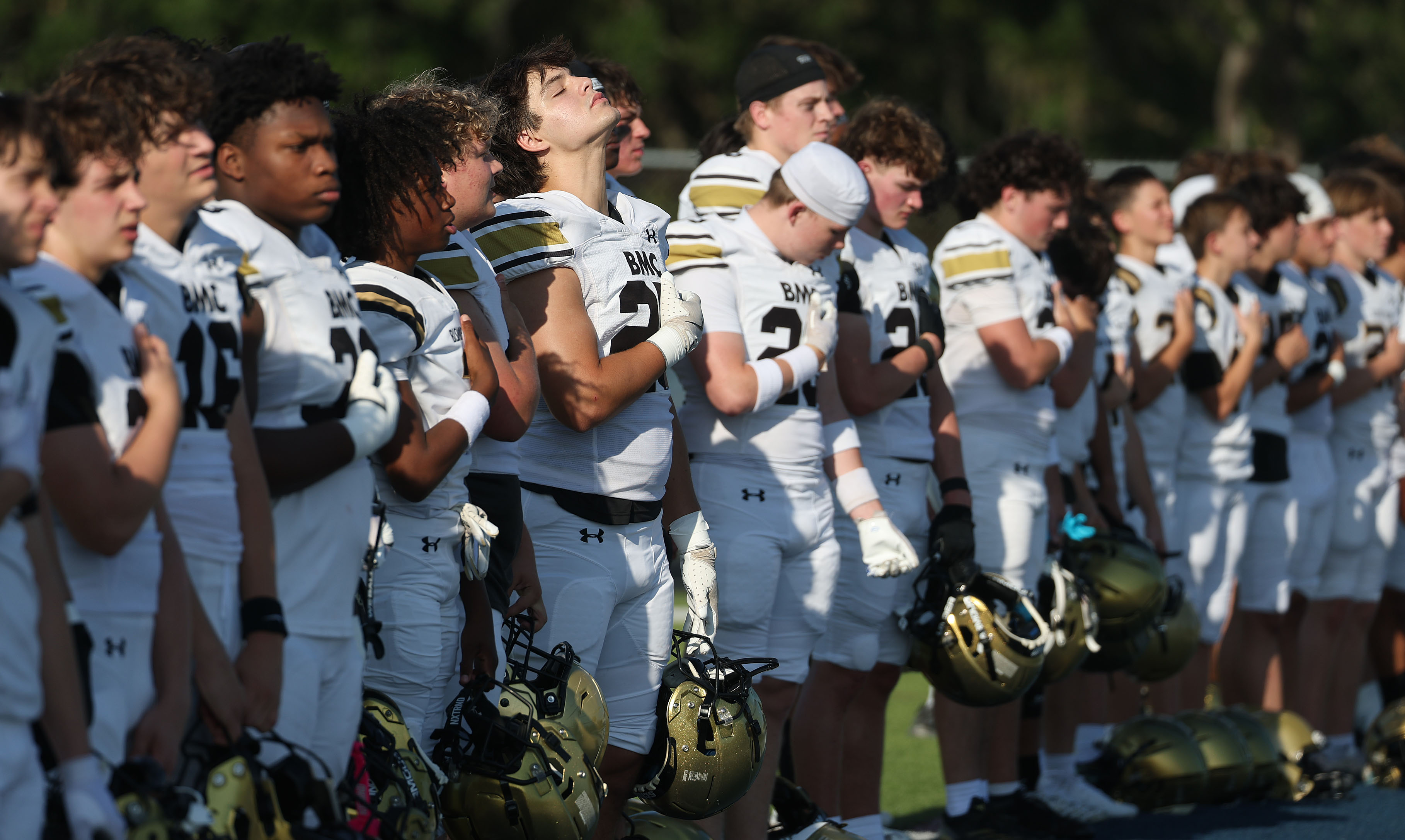 Bishop Moore players are pictured during the national anthem before...