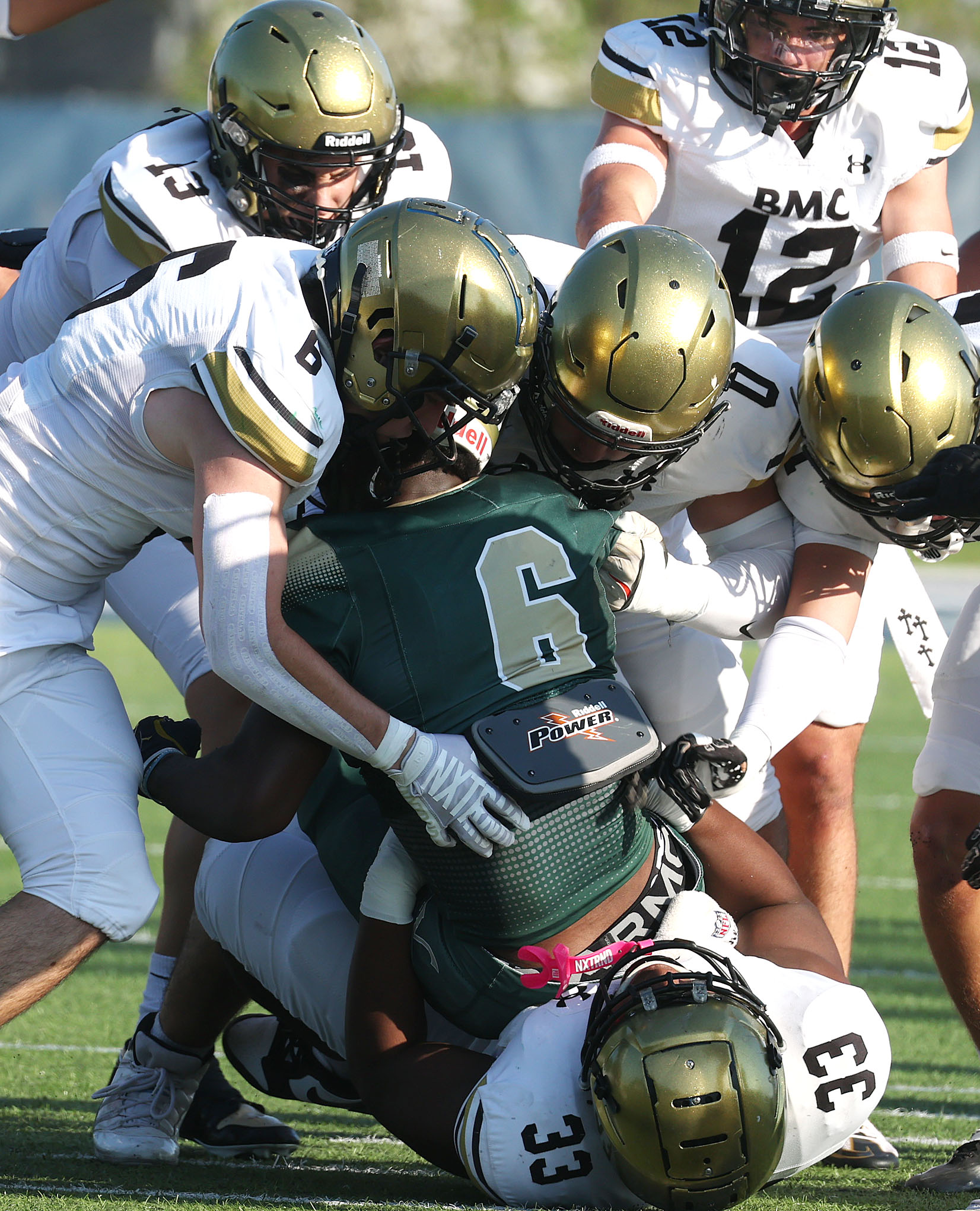 Several Bishop Moore defenders engulf The Villages running back Tranard...