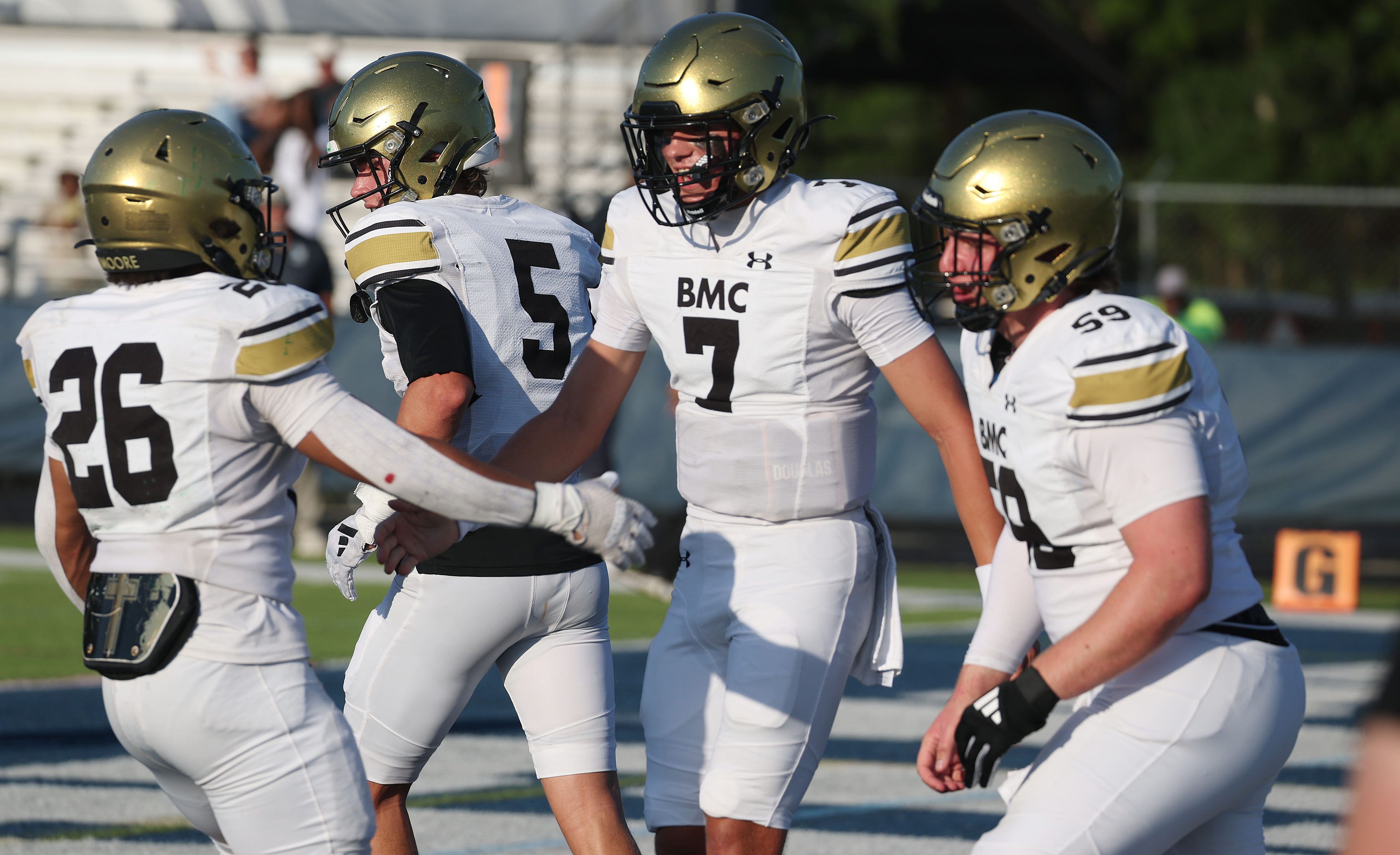 Bishop Moore quarterback Blake McCullough (7) celebrates with teammates during...