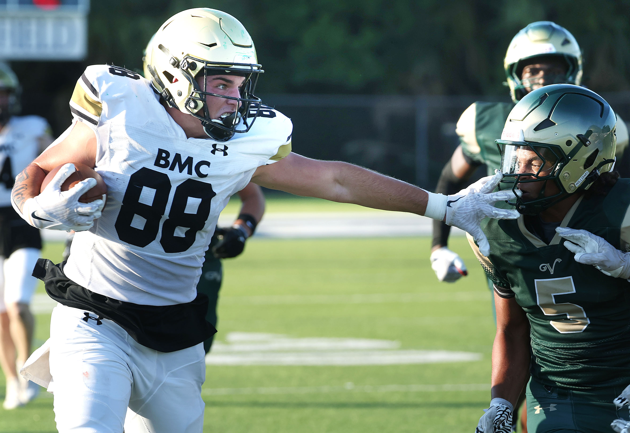 Bishop Moore tight end Drew Follett (88) shoves away The...