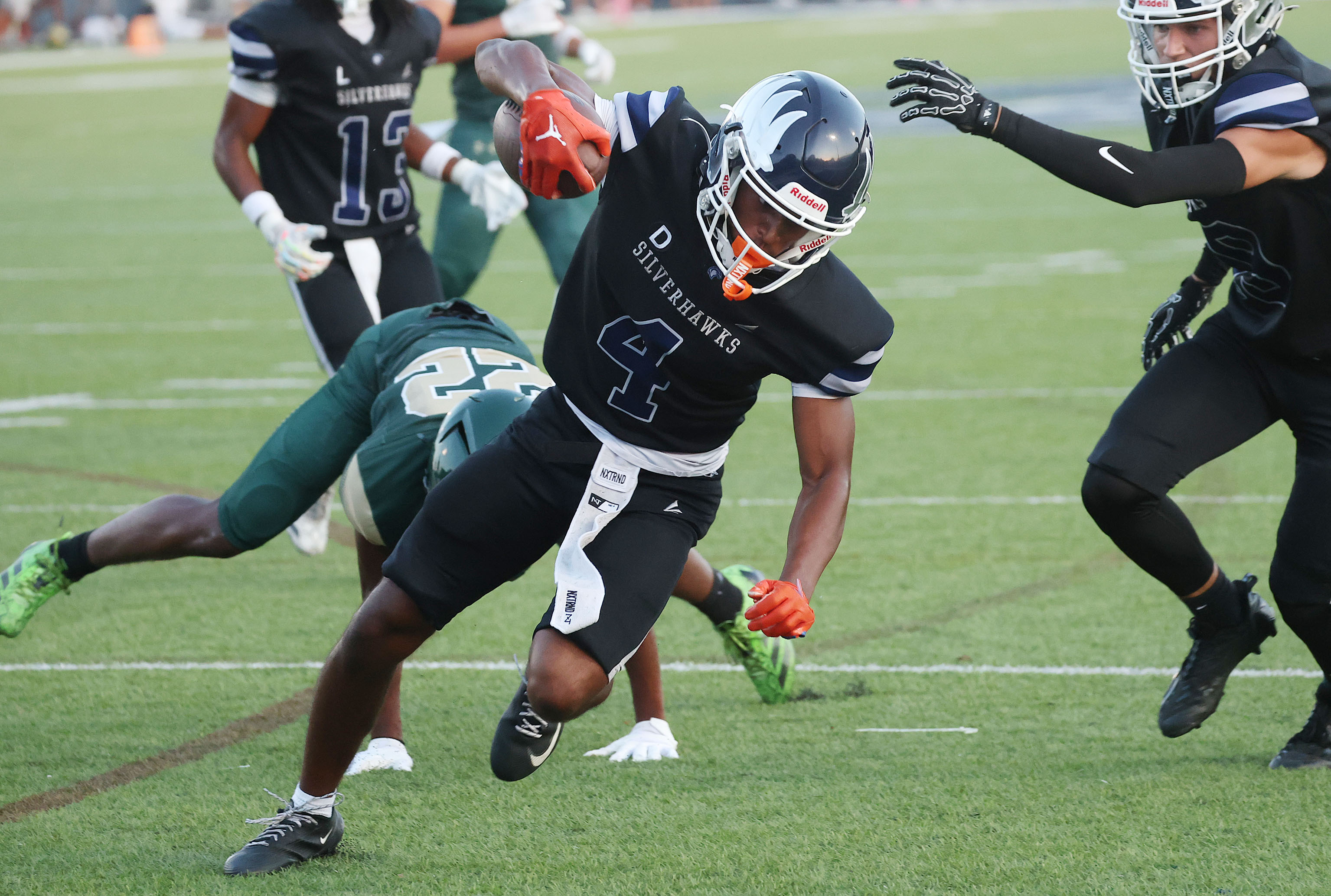 Lake Howell athlete Jayvon Funnye (4) reaches toward the endzone...