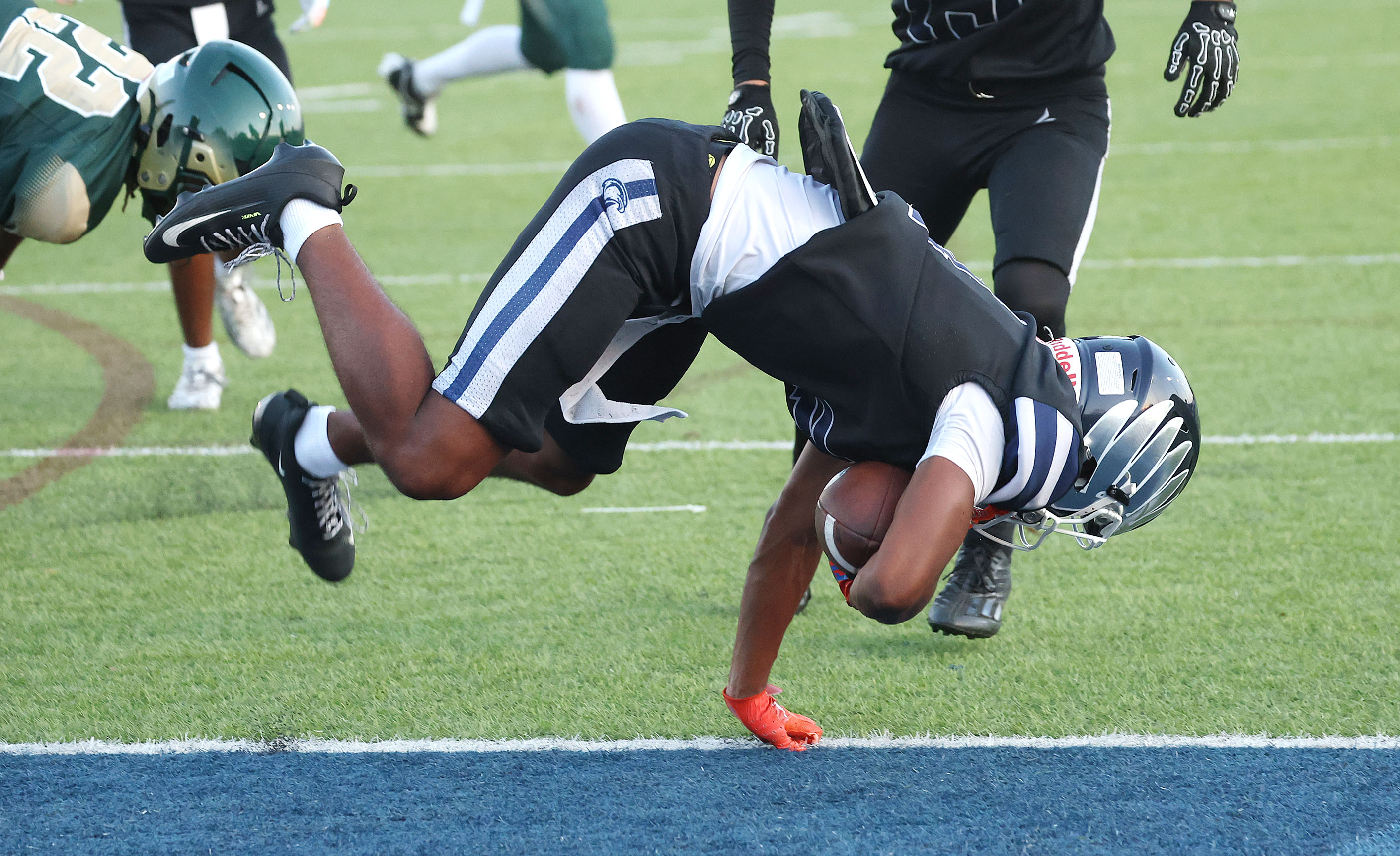 Lake Howell athlete Jayvon Funnye leaps into the endzone for...