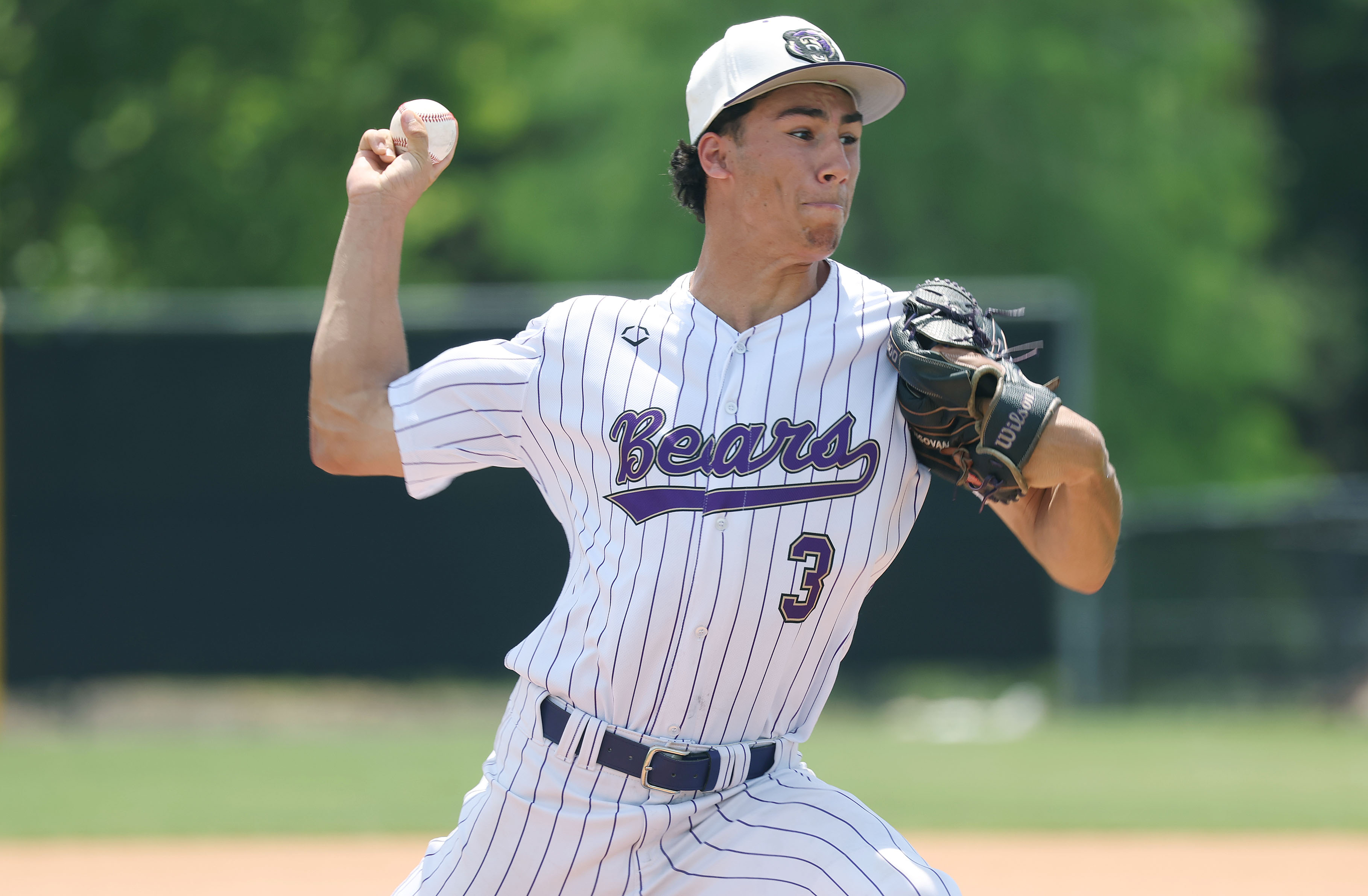Winter Springs High baseball pitcher Robbie Mungovan throws during the...