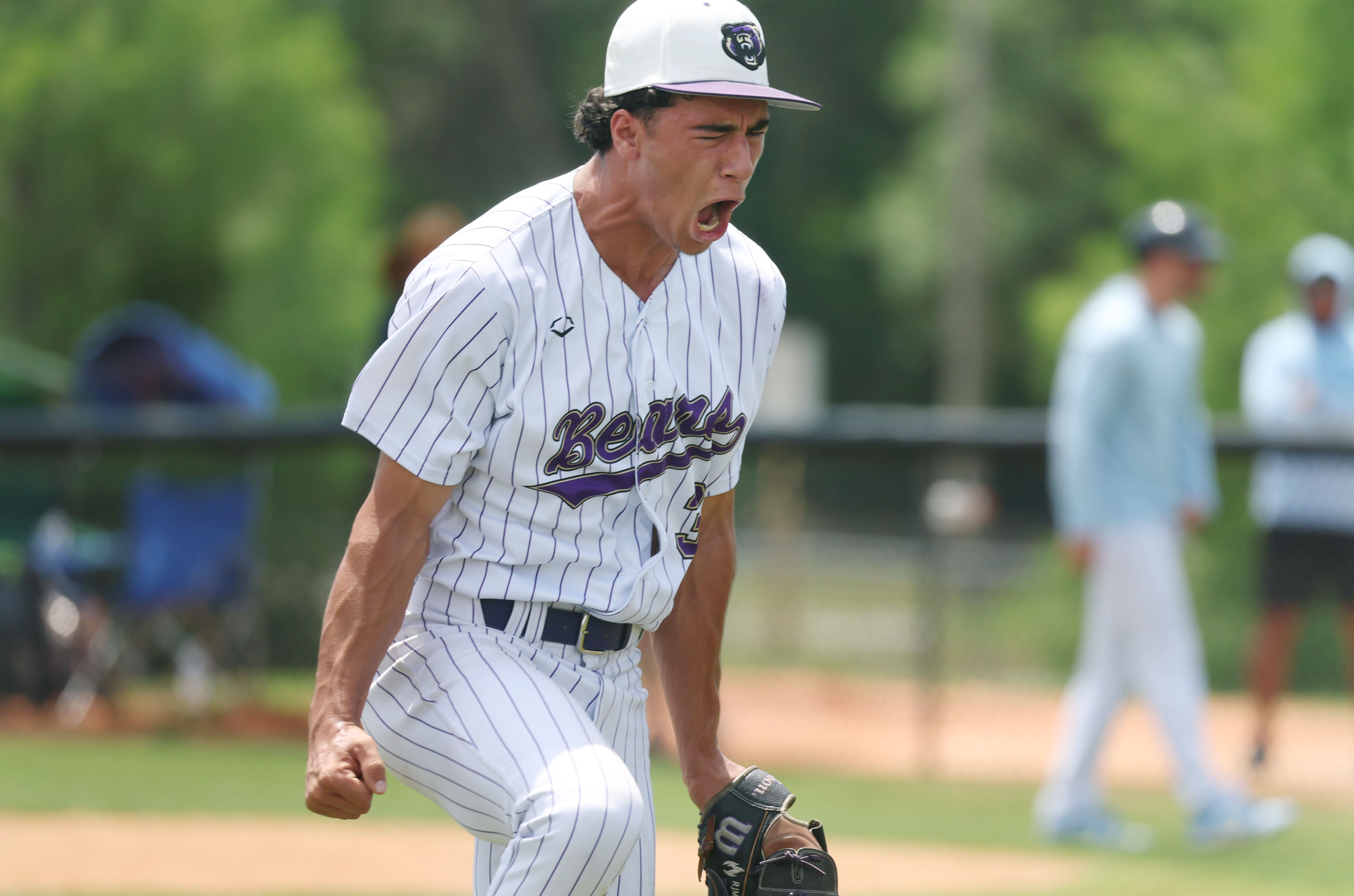 Winter Springs High baseball pitcher Robbie Mungovan screams in celebration...